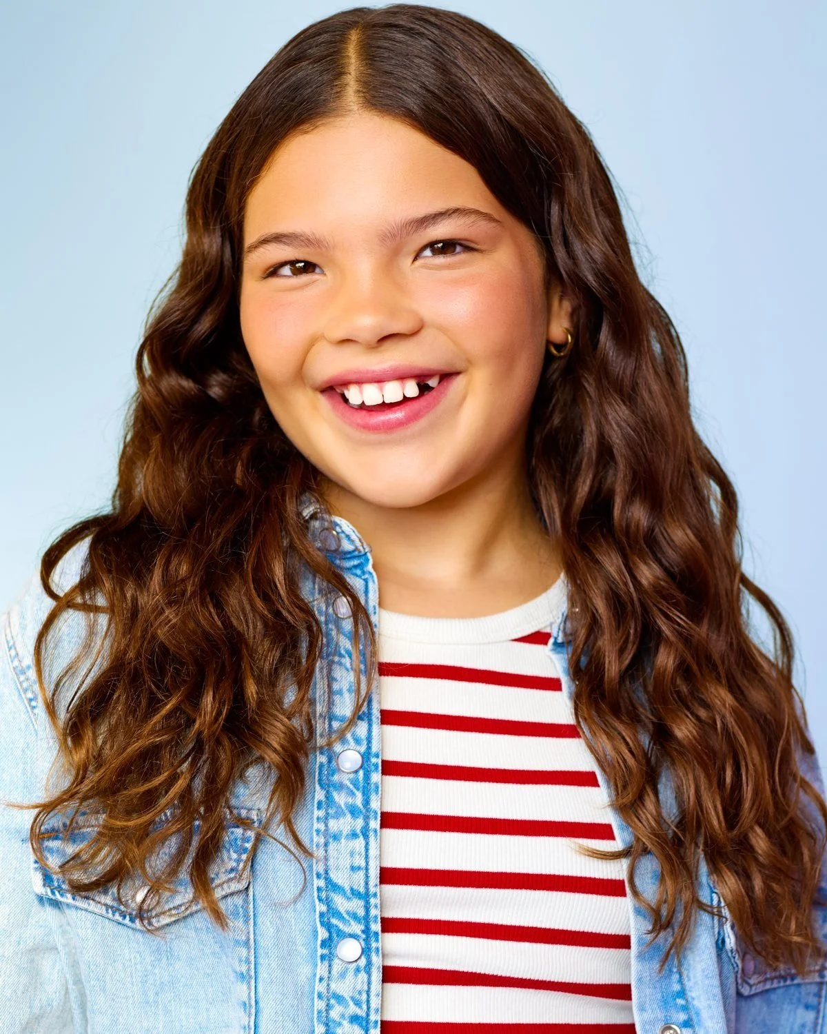 Professional kids headshot in a blue jacket and stripped shirt taken at our Toronto studio.