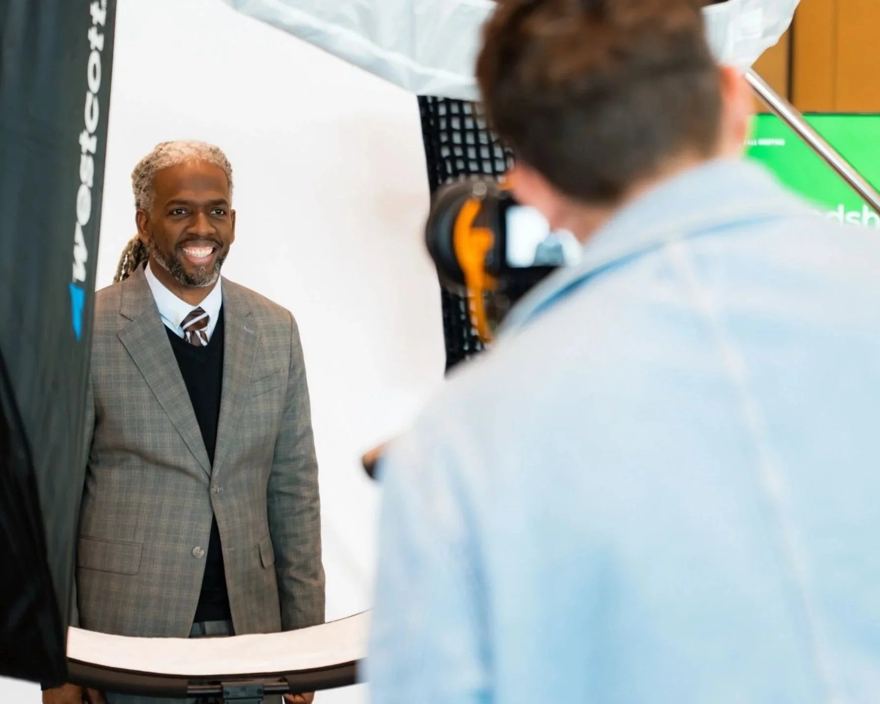 Man at corporate conference getting headshots taken