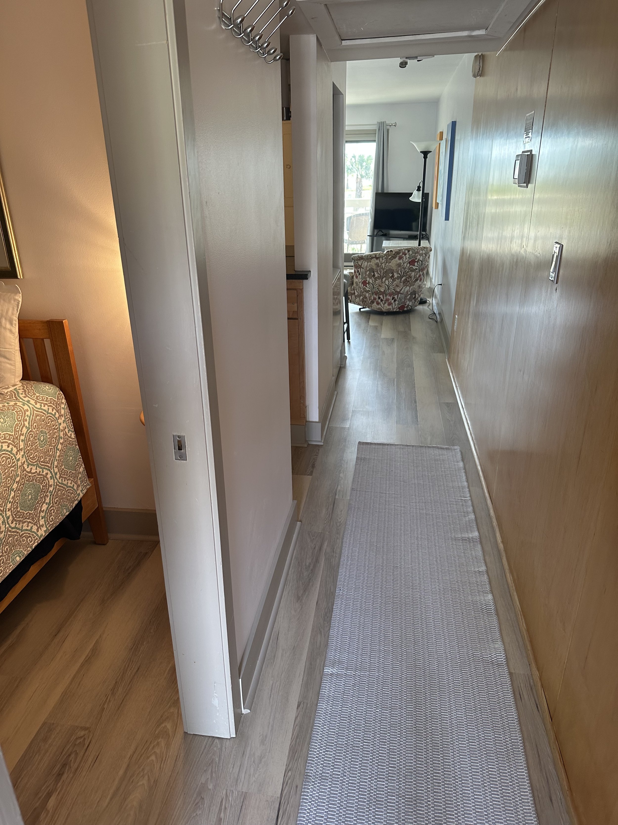 FOYER ENTRANCE WITH POCKET DOOR FOR BEDROOM PRIVACY.