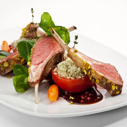 stock-photo-roasted-lamb-chops-with-pistachio-garnished-with-vegetables-and-basil-63248404.jpg