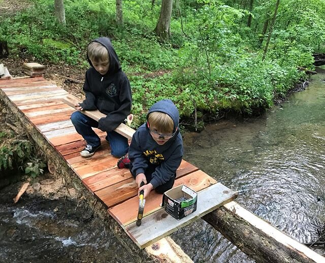 Homeschooling, The Forest Gully way, by learning to swing a hammer. Boys are helping finish our cedar bridge across creek for y&rsquo;all! Hope you like the new addition.  #cedarbridge #homeschooling #workteachschool #carefulcrossing