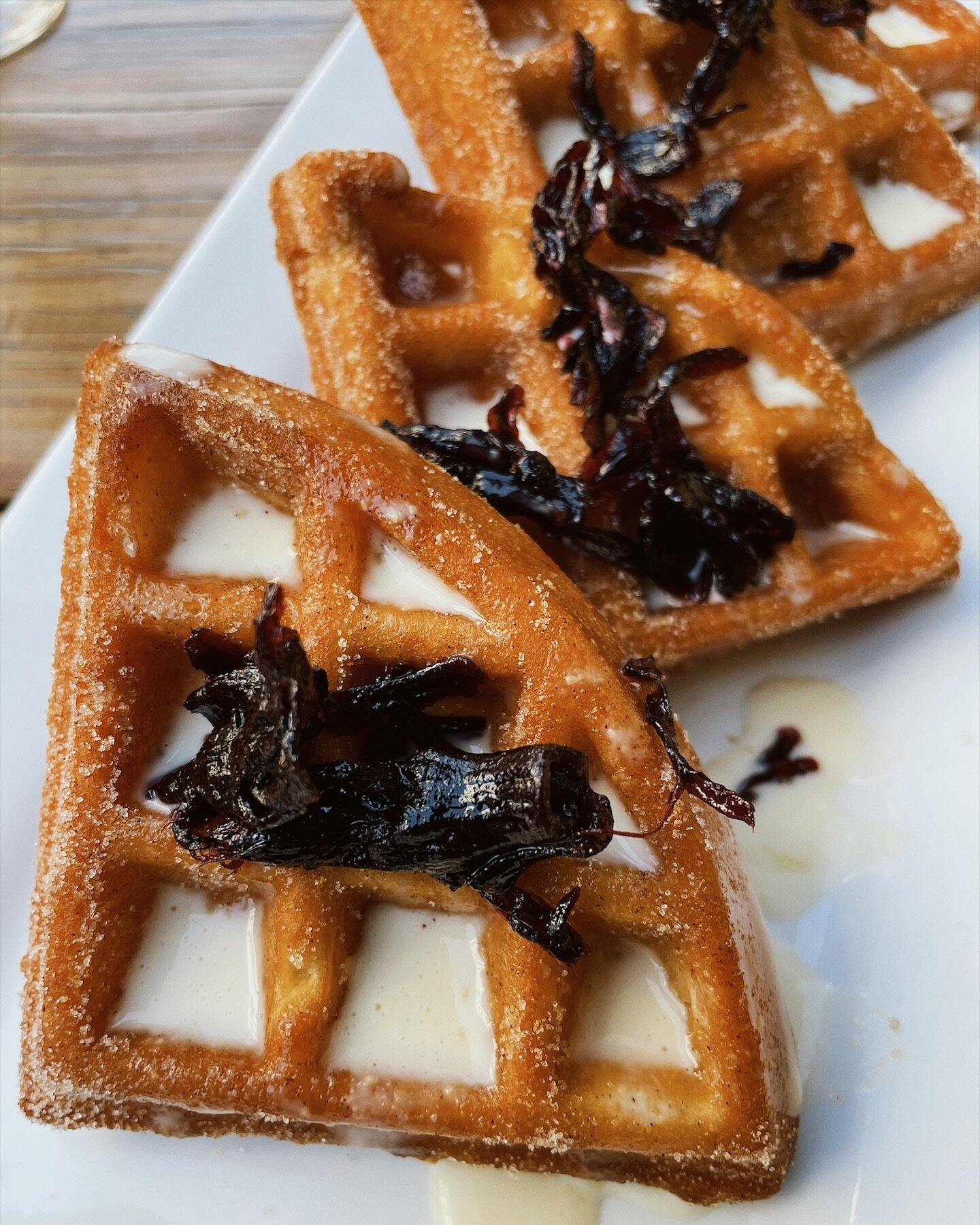 Get up close and personal with our Burro CHURRO Waffle! 🧇 A cinnamon-sugar waffle with creme anglaise sauce &amp; jamaica petals.