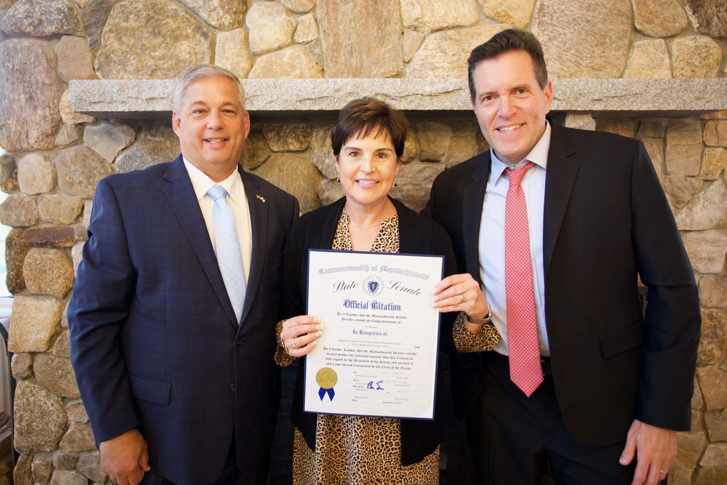 Massachusetts State Senators Bruce Tarr (left) and Barry Finegold (right), present Eva with a citation from the Massachusetts State Senate.