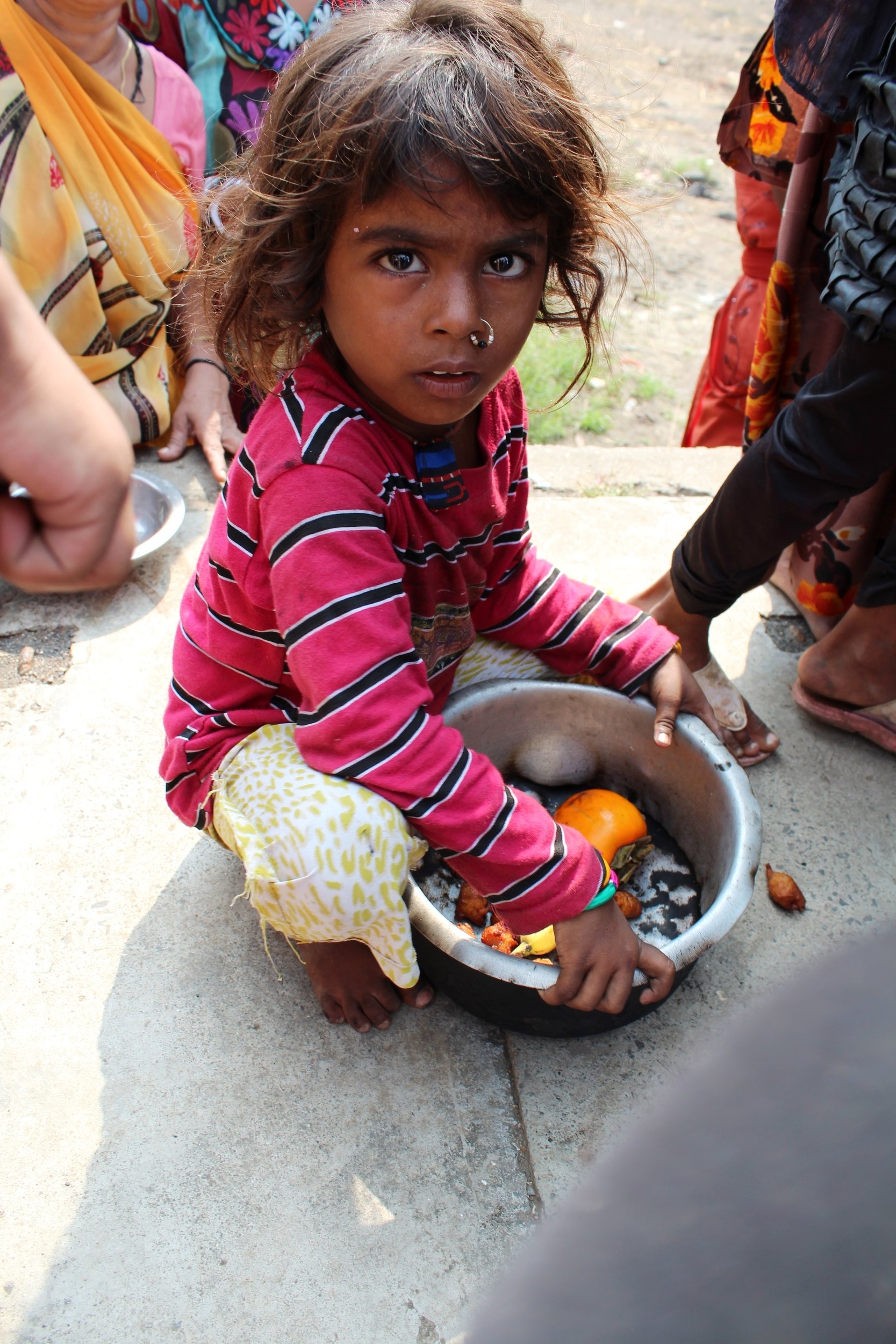 homeless child with donated food to eat.JPG