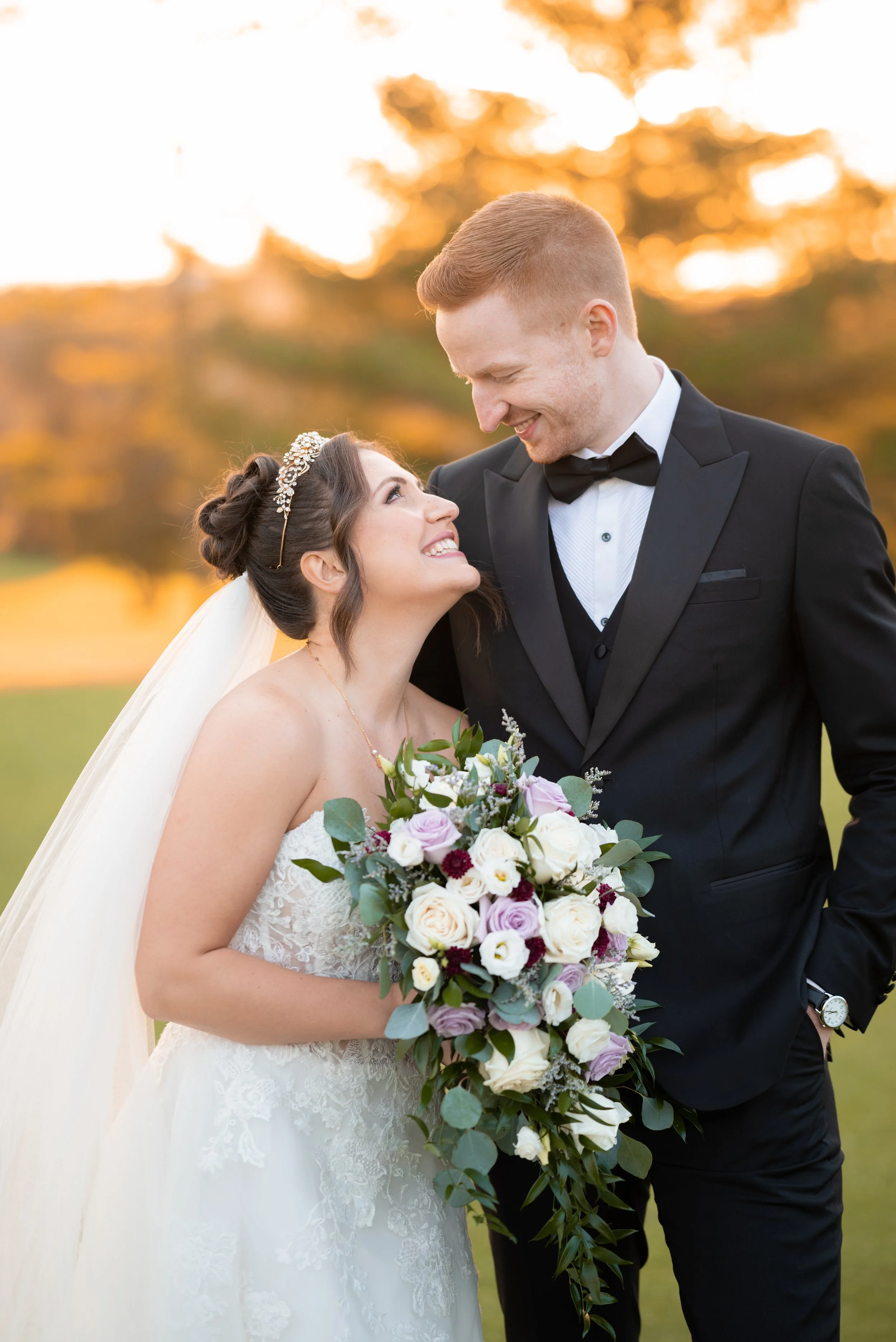 Bride and groom smiling at each other during golden hour at Deer Creek in Ajax, Ontario