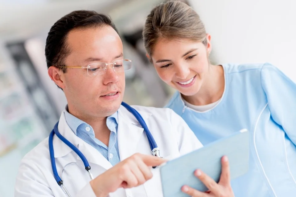 Doctor at the hospital talking to a nurse.jpeg