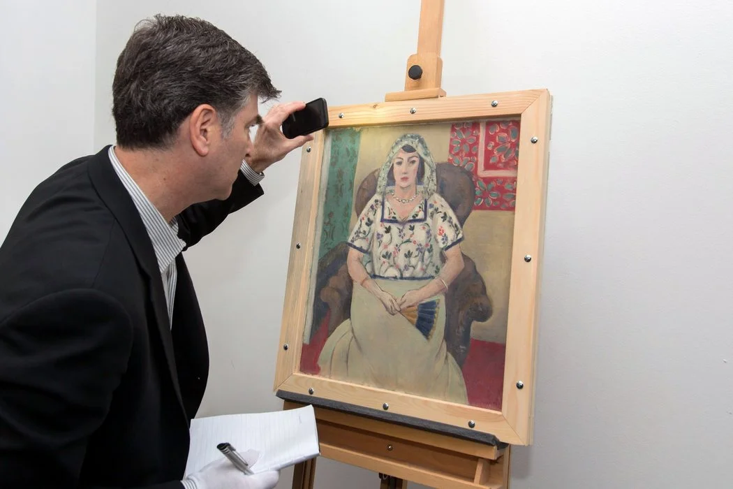 Christopher A. Marinello, a lawyer who specializes in tracking down looted and stolen art, with the recovered Matisse, "Femme Assise,"