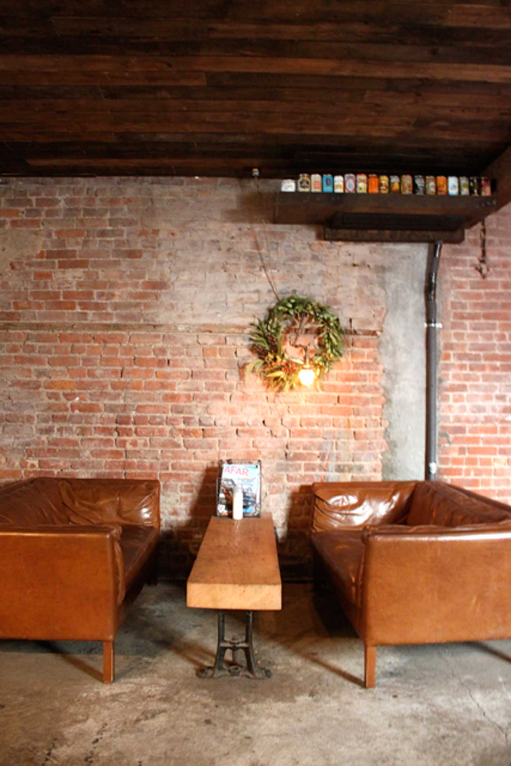alphabet city beer co reclaimed wood table and leather sofas