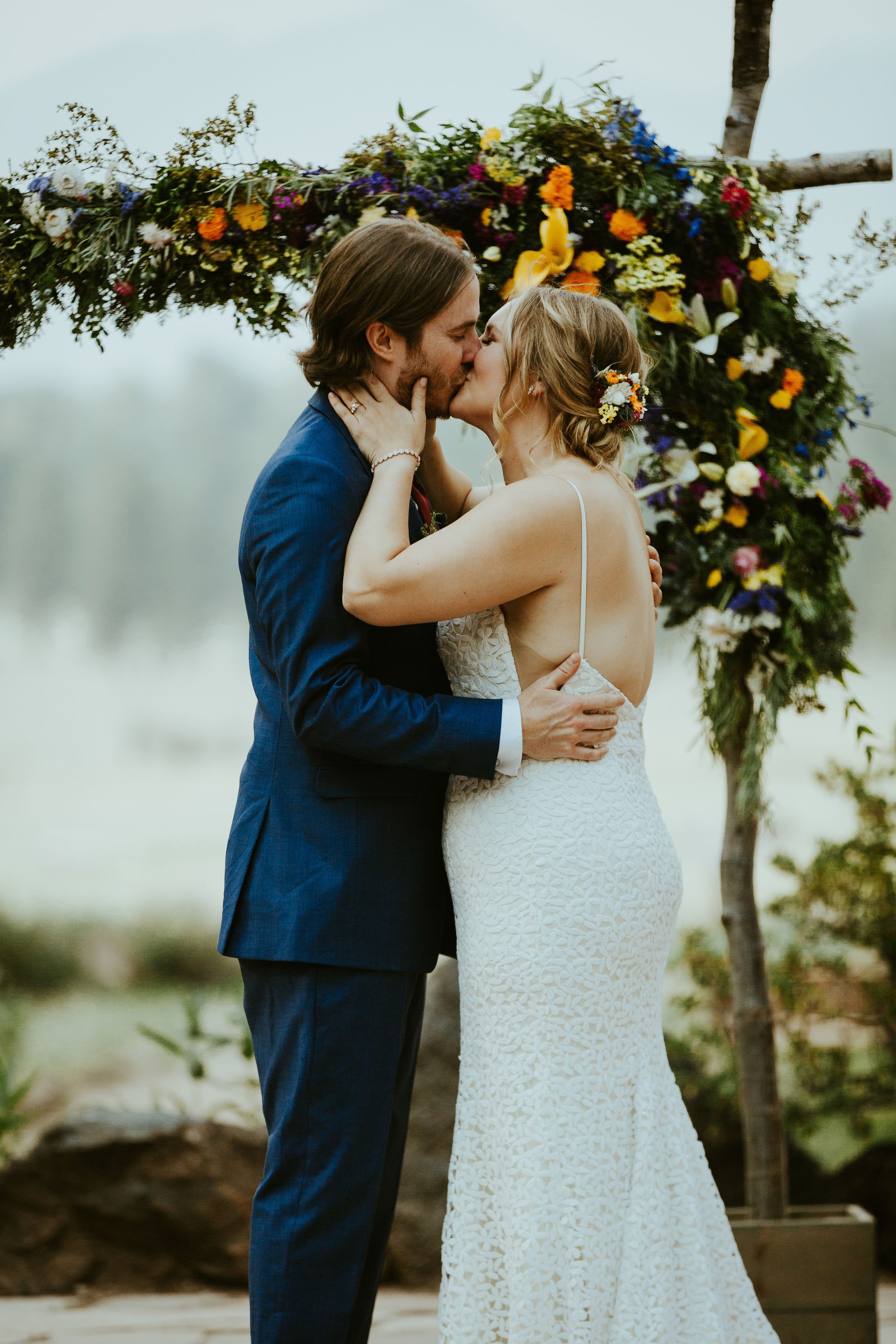 Bold bohemian wildflower wedding kiss