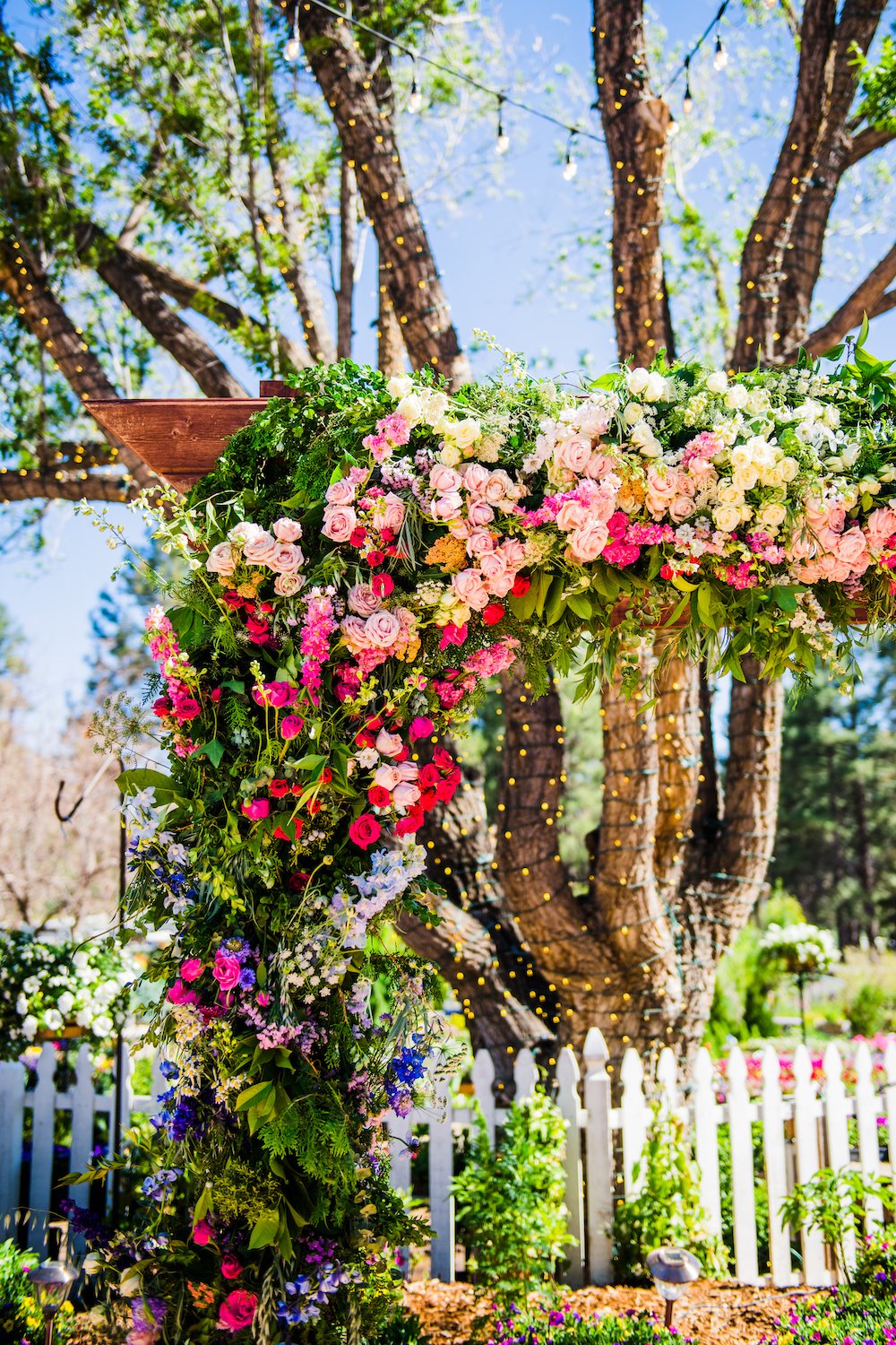 Romantic colorful garden wedding arch detail