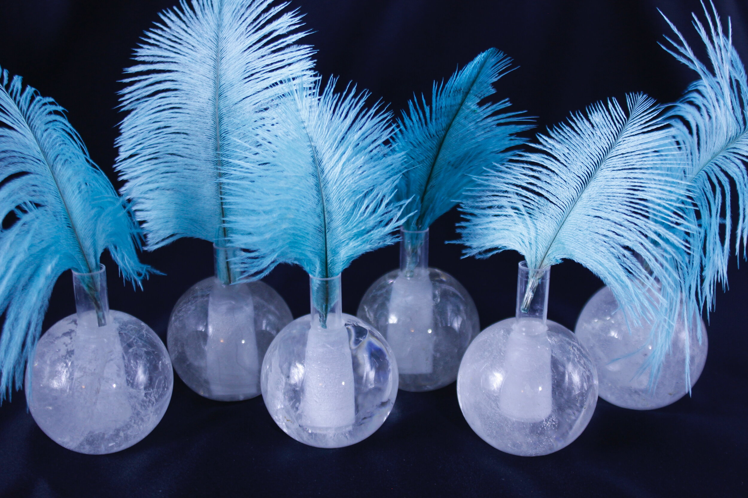 A collection of 6 Quartz spherical single stem vases