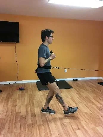 Forward "soft" single leg squat landing against cable (holding weight for core challenge)