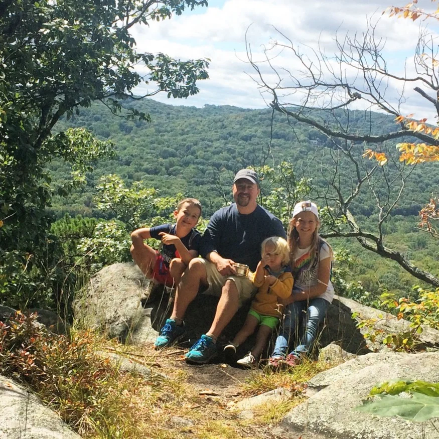 Rebekah with her dad and her brothers hiking
