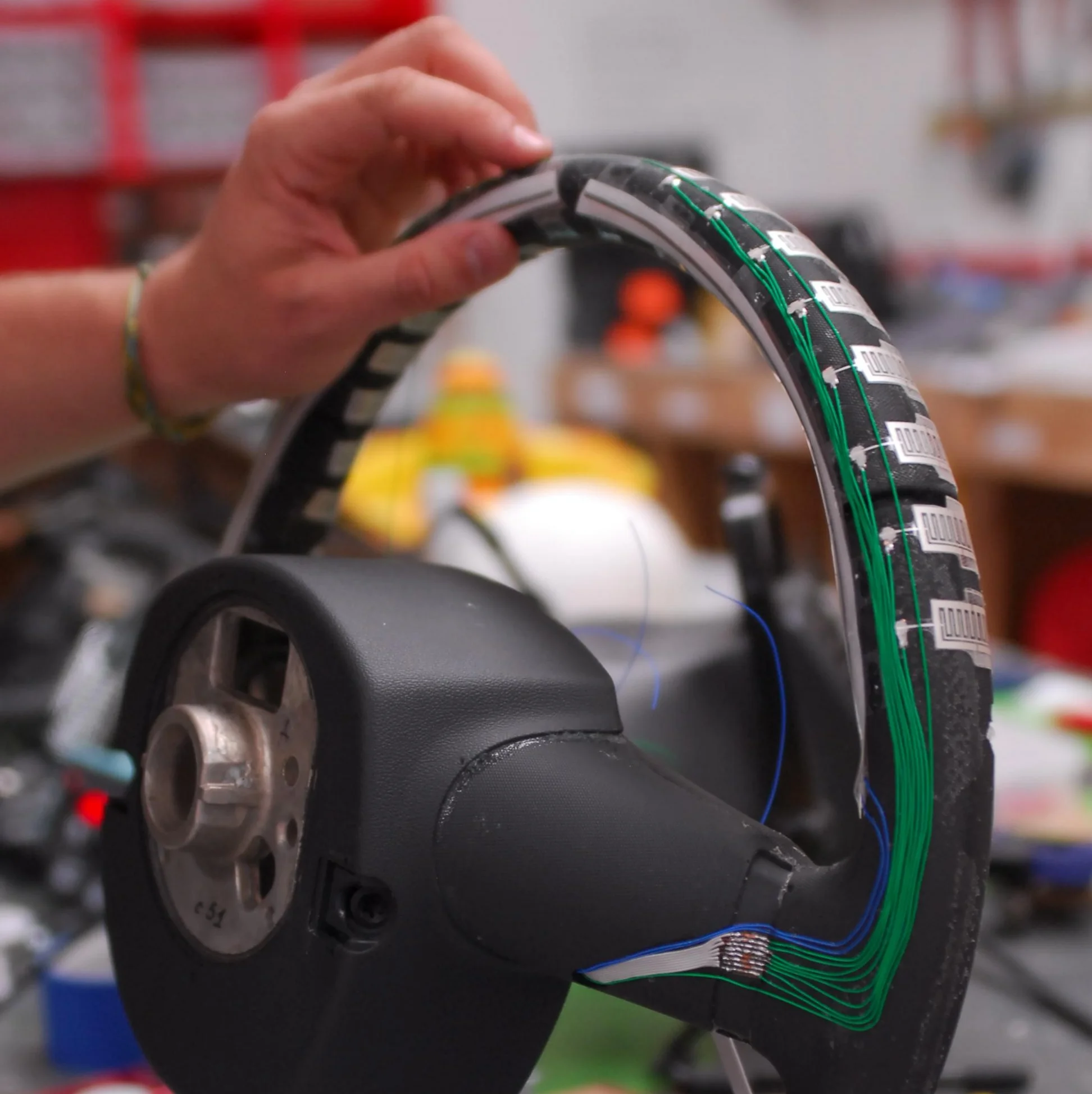  Photo of screen-printed capacitive grid adhered and wire intricately routed prior to lacing the leather 