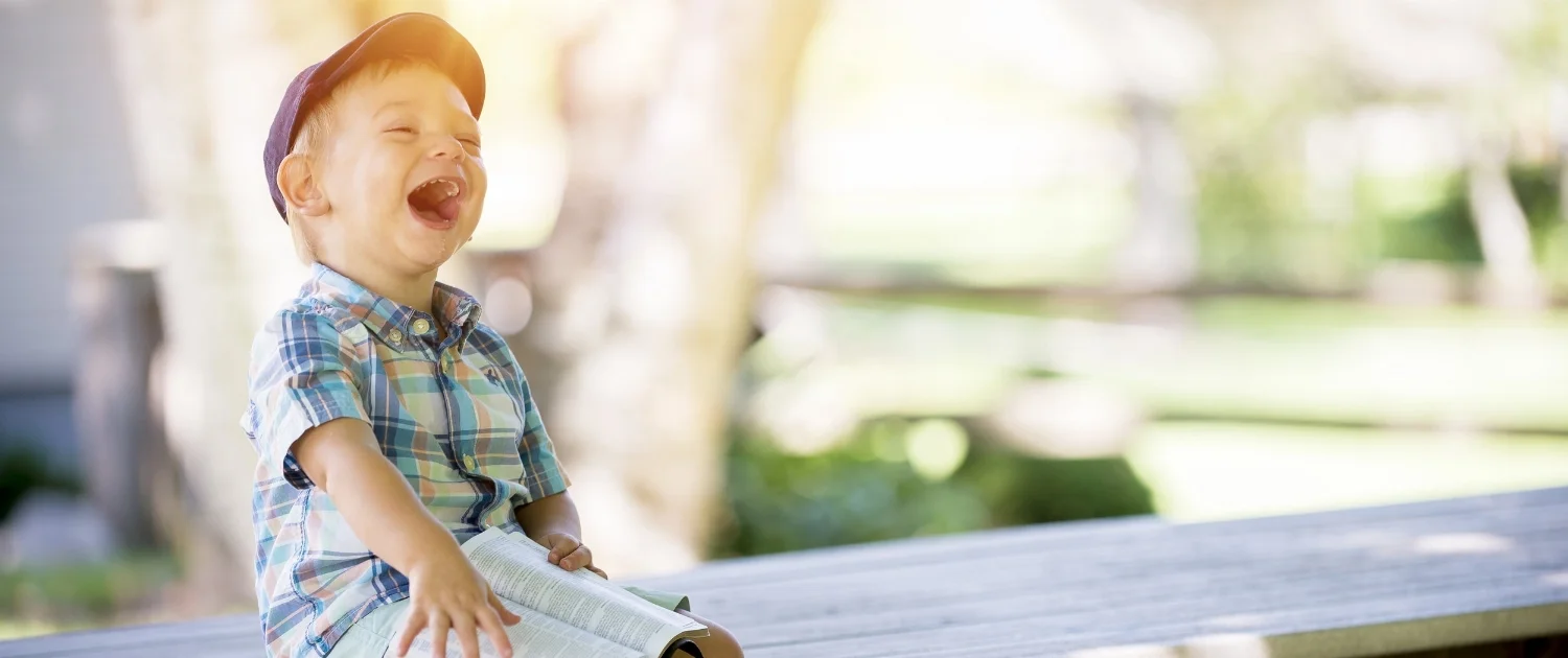 boy laughing with bible.jpeg