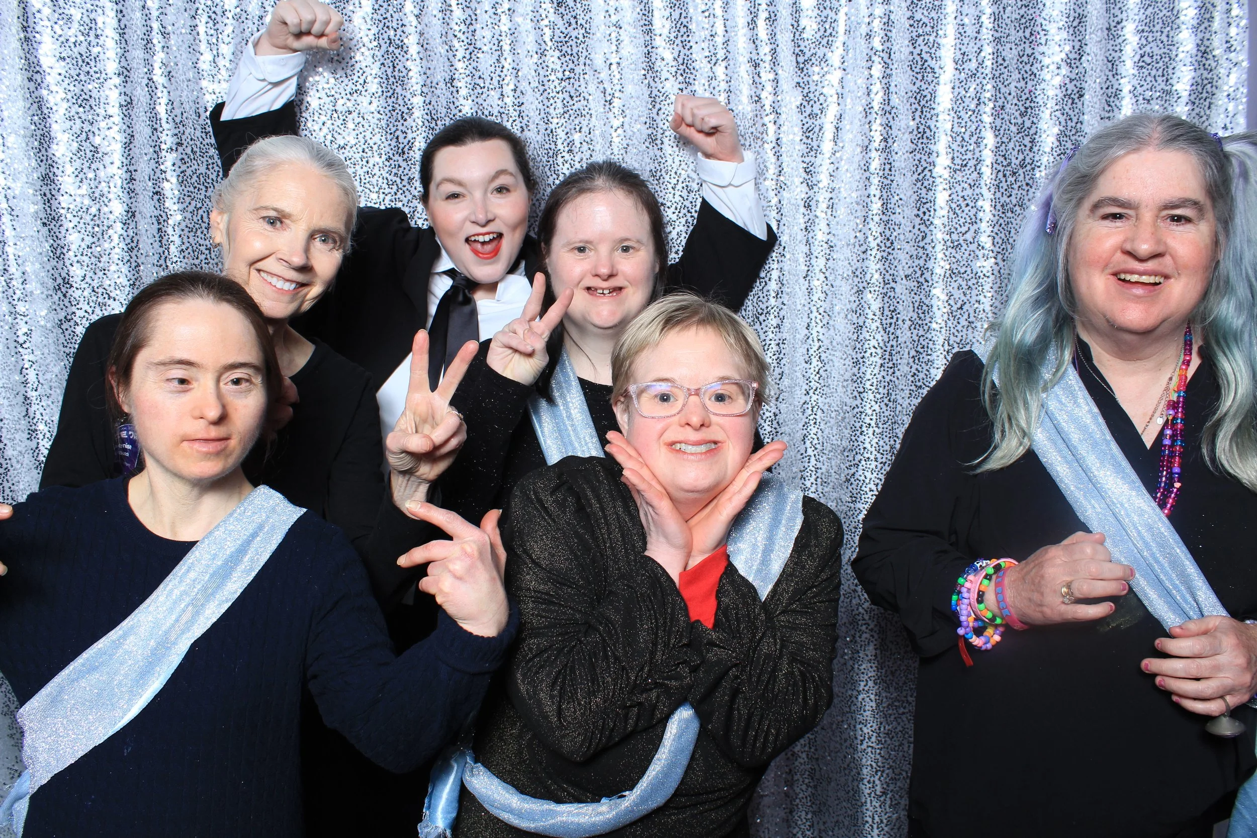 A series of playful photo booth images featuring PHAME community members posing together with reflective backdrops and props.