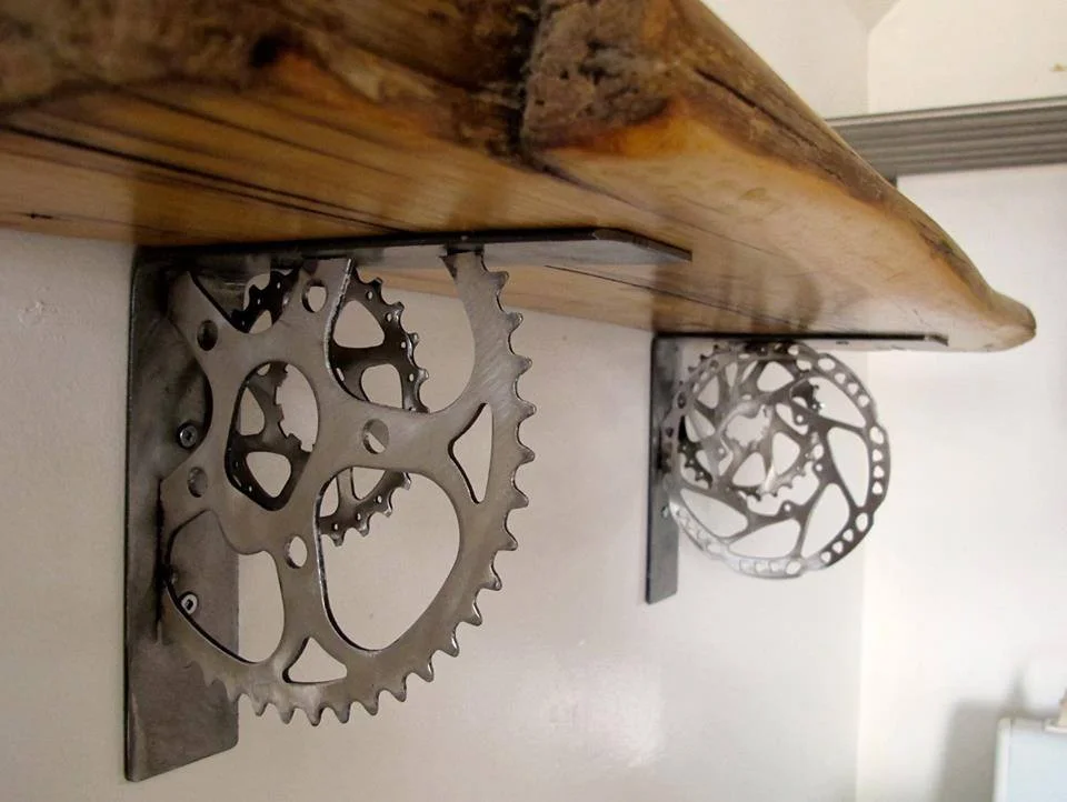 Giving 'em the grind - These shelf brackets are made from old salvaged gear rings. Available for custom orders with or without wood shelf.
