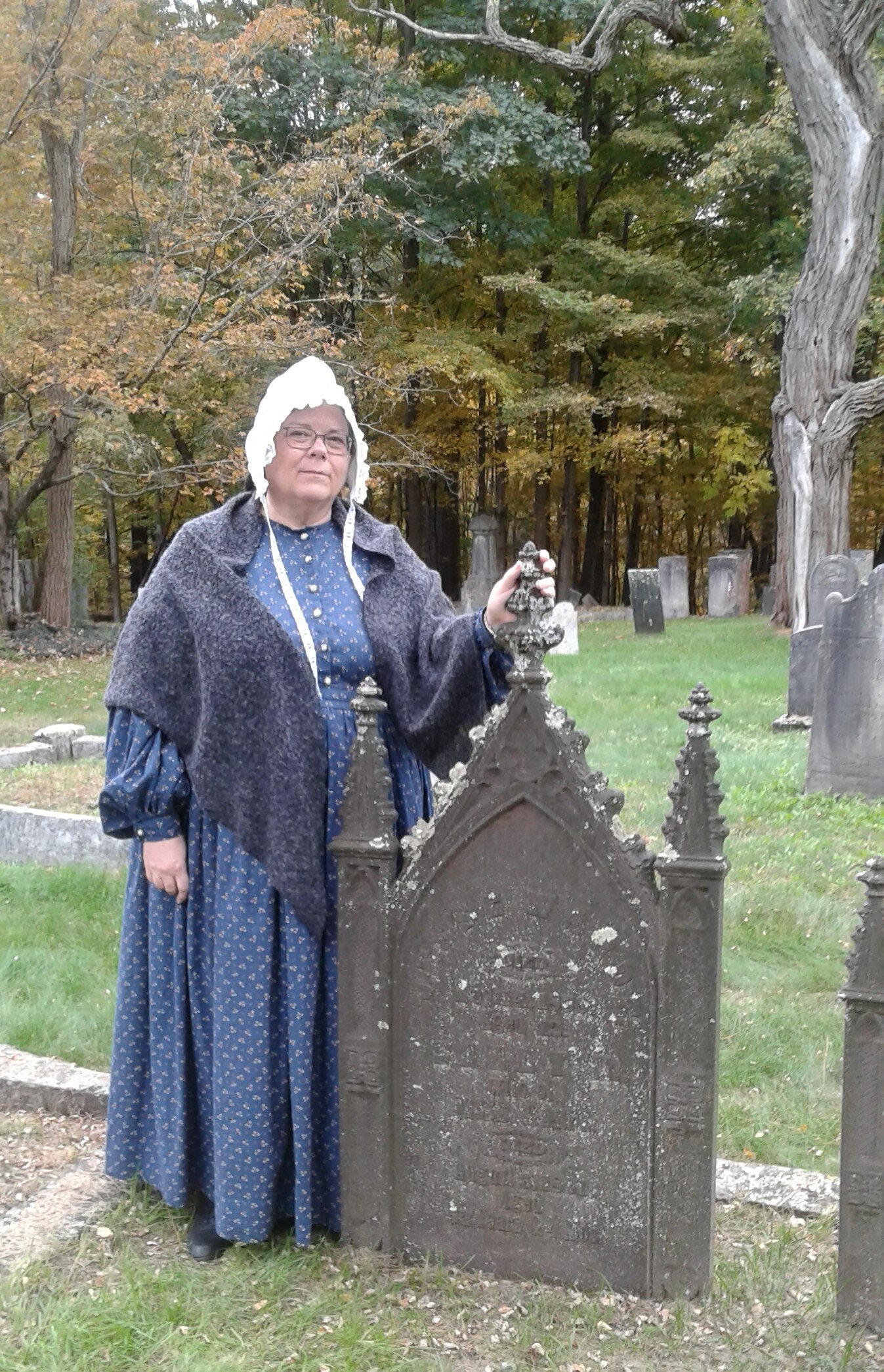 Mrs. Ward notes the unusual iron tombstone