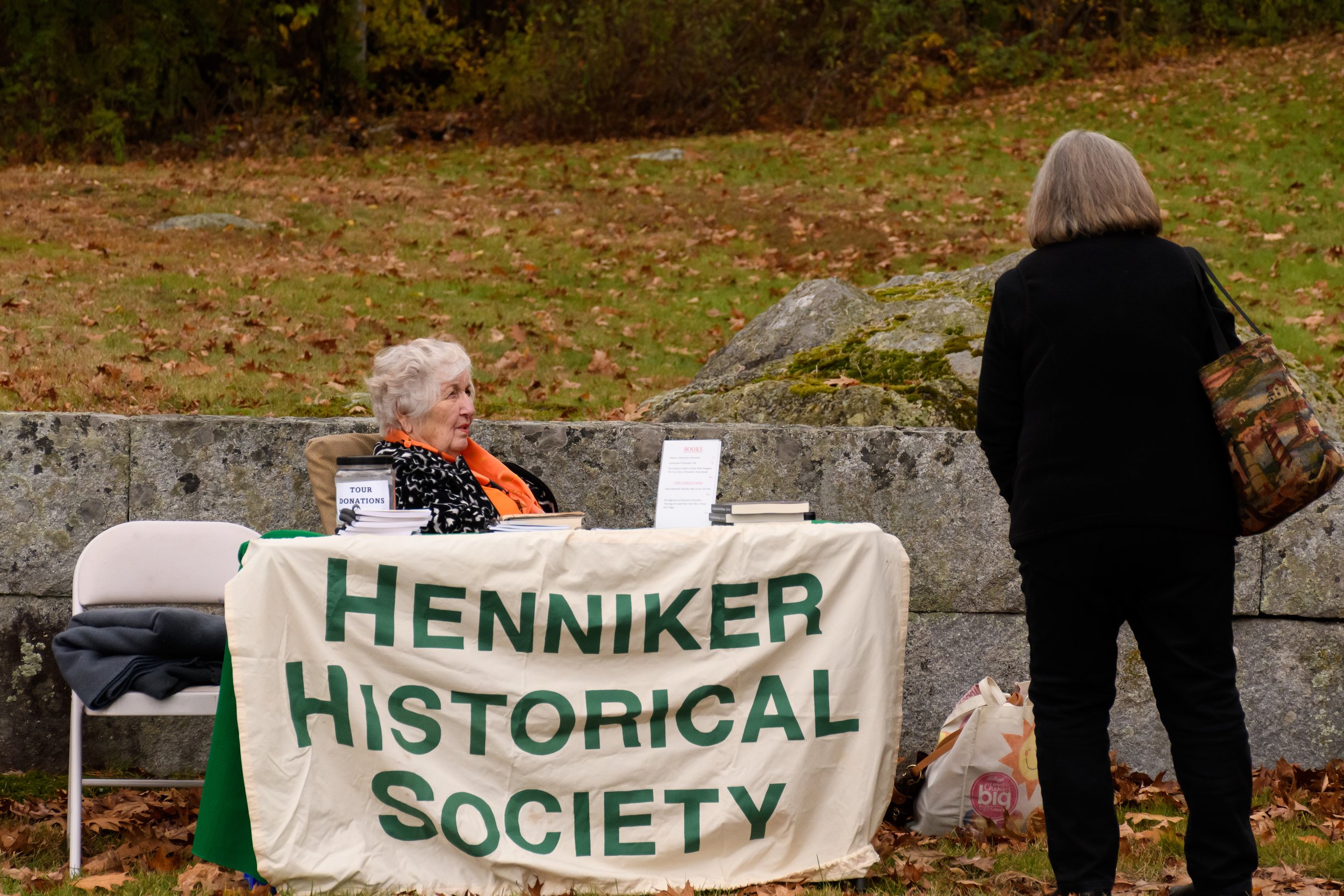  HHS Volunteer, Diane Carpenter, greets a cemetery toursit. 