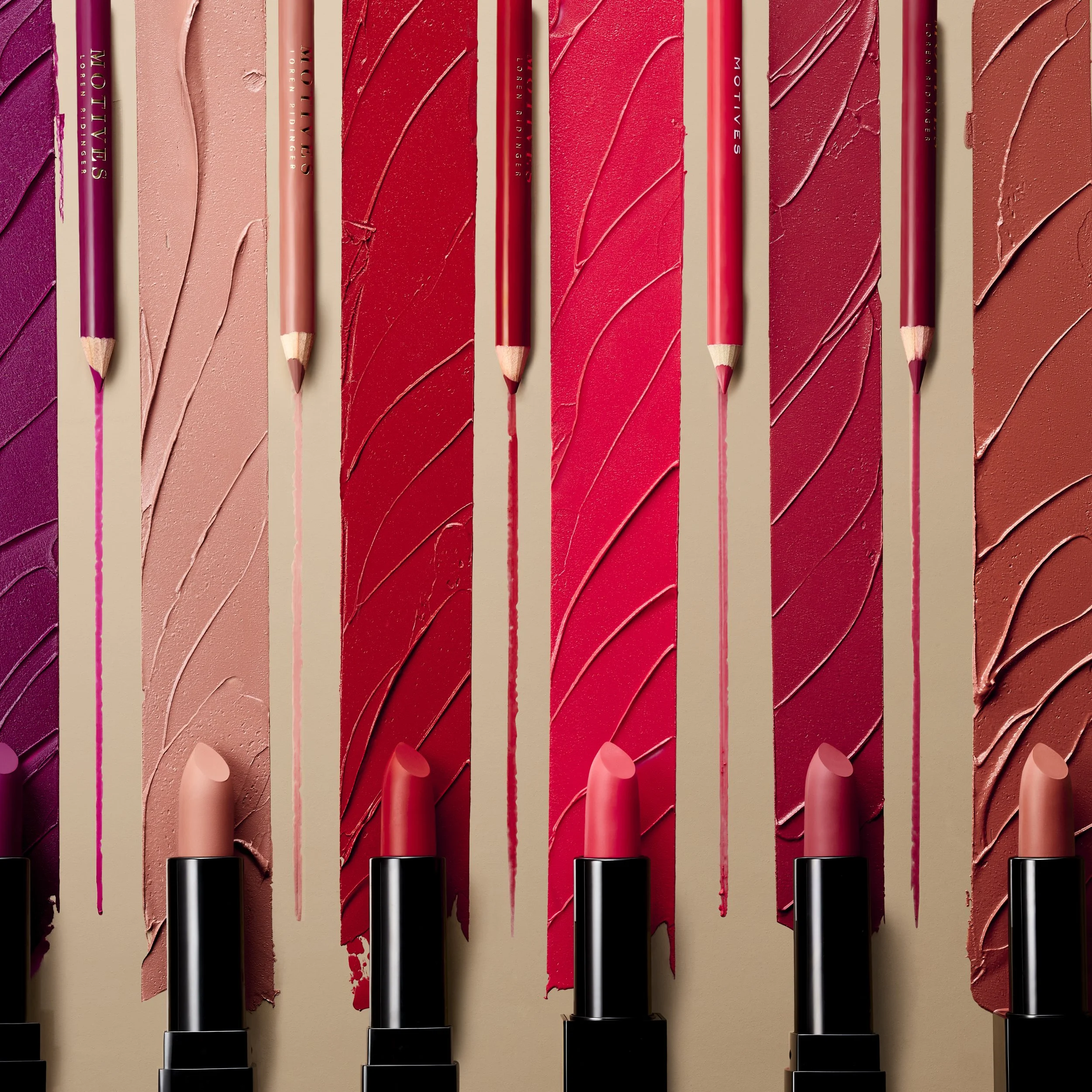 Row of lipsticks with matching lipstick swatches and lip liner pencils in varying shades of pink, red, and nude.