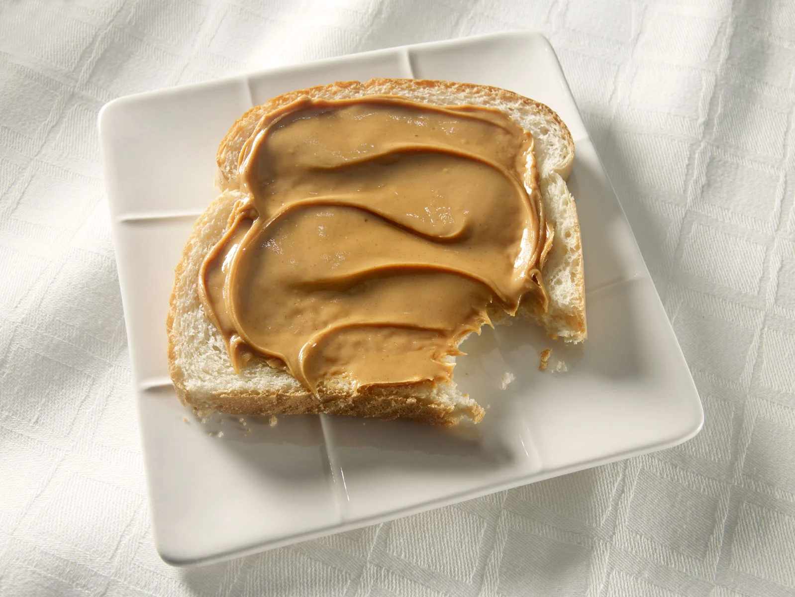 peanut butter on white bread, bite, dessert, food, food photographer, Long Island food photographer, product photographer, photographer, studio photographer, packaging, John Montana