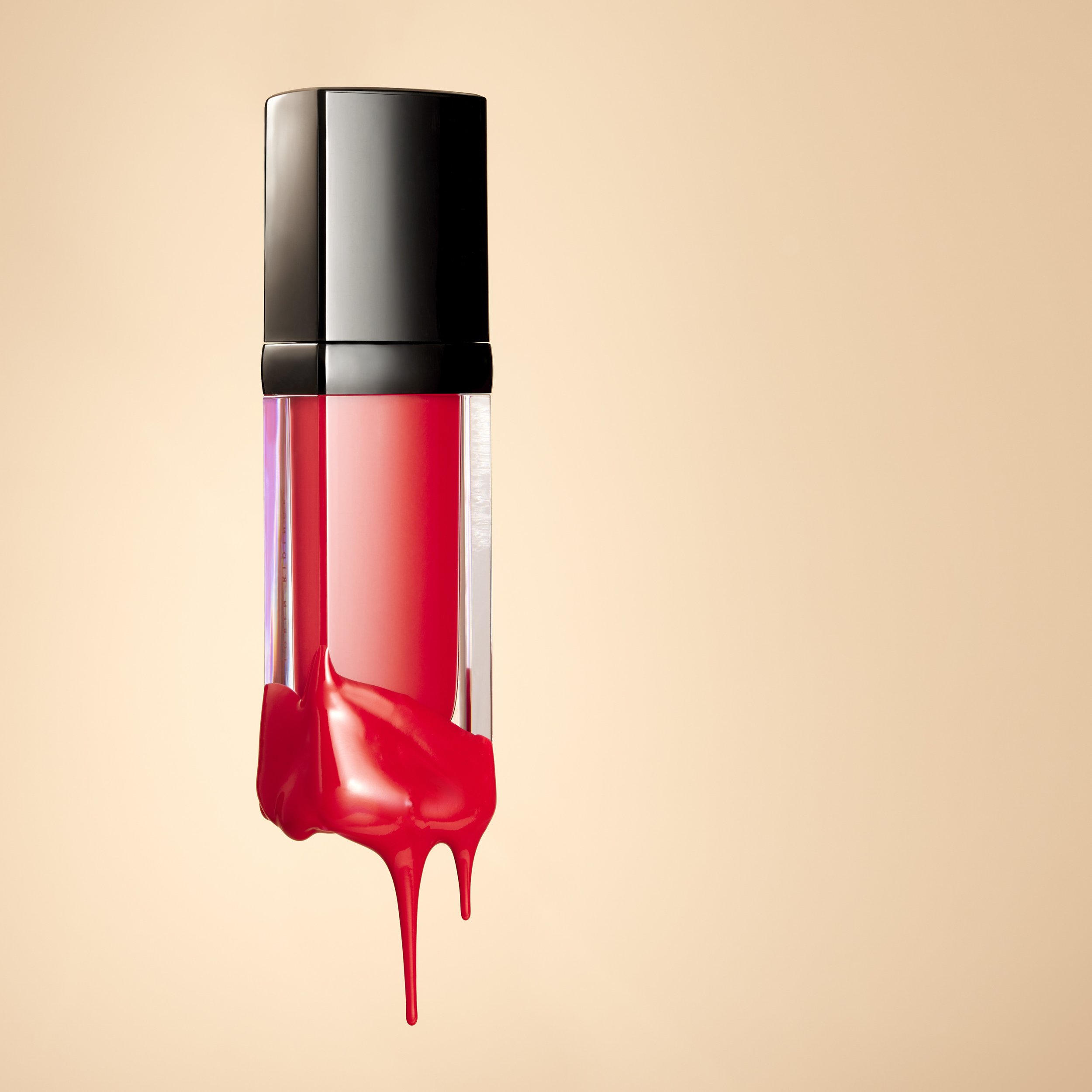 Lip gloss tube with red gloss dripping down