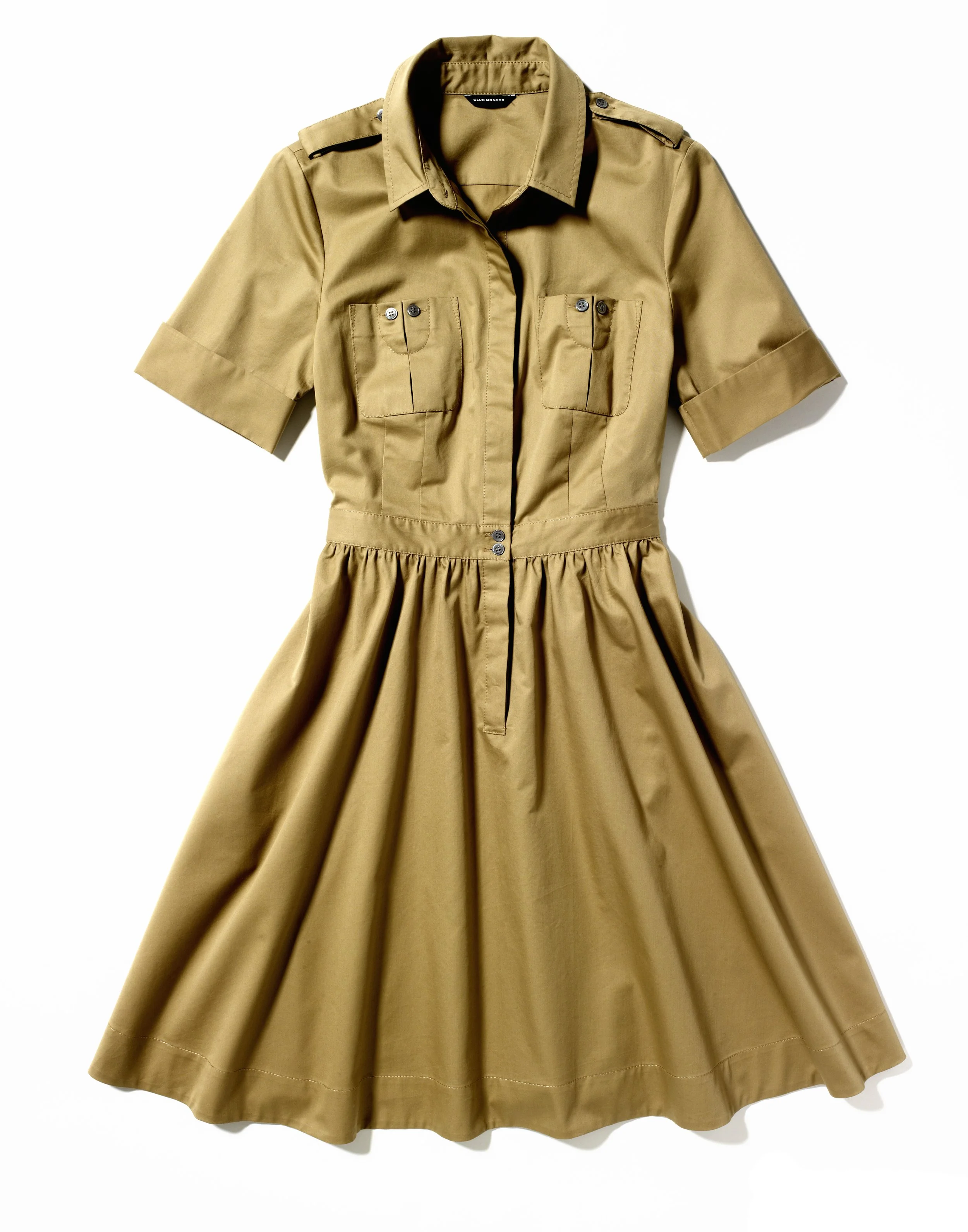 A tan dress with short sleeves, a collared neckline, button details, and a gathered skirt, displayed on a flat surface.