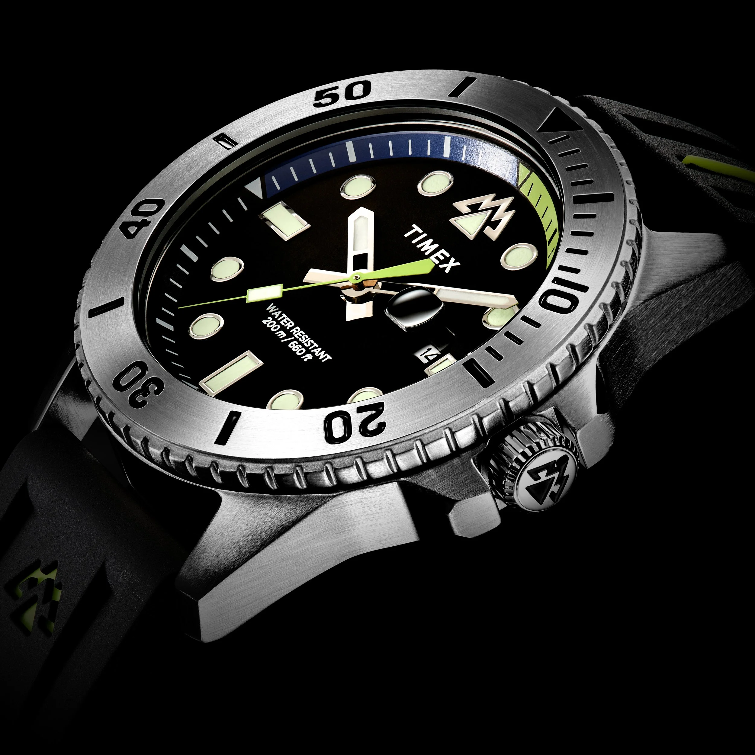 Close-up of a Timex diver watch with a black dial, luminous markers, and a rotating bezel, showing the time and date.