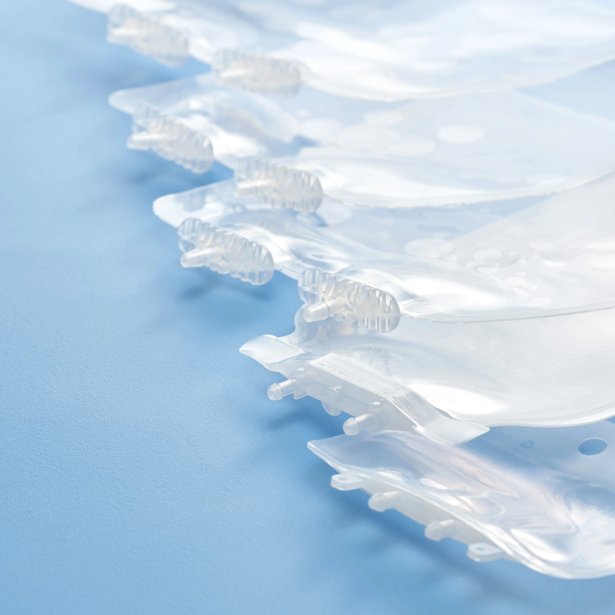 Close-up of clear plastic packaging or blister pack on a blue surface.