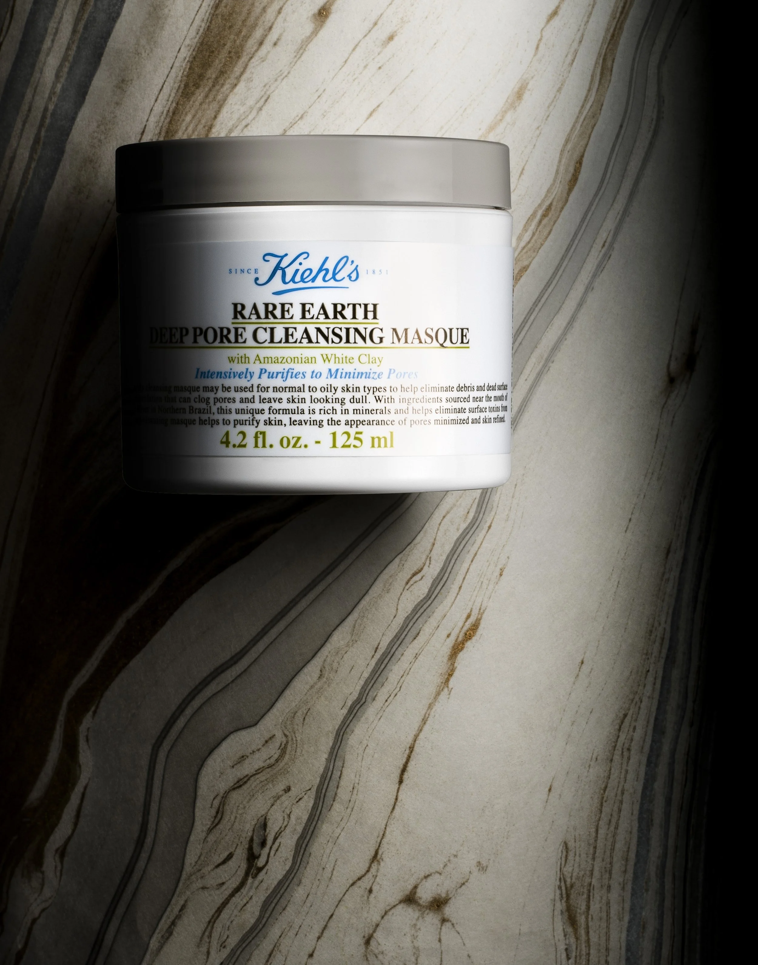 Kiehl's Rare Earth Deep Pore Cleansing Masque container on a marble surface.