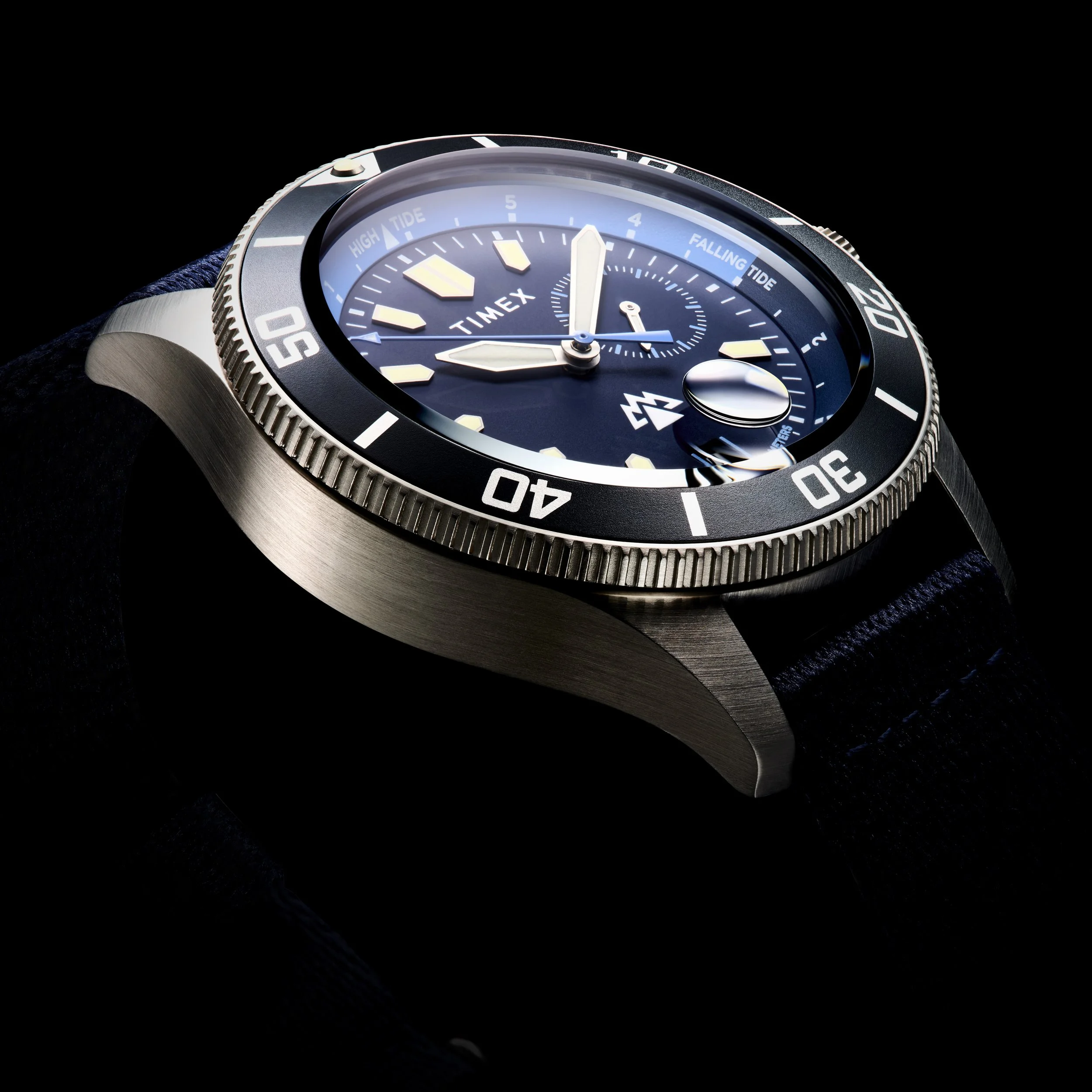 Close-up of a Timex wristwatch with a blue dial, rotating bezel, and leather strap against a black background.