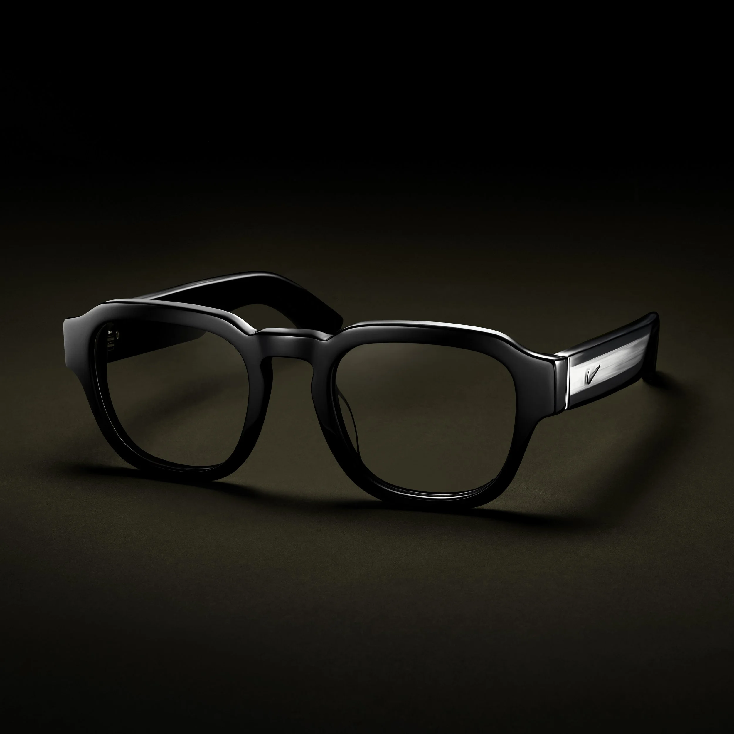 Close-up of a futuristic black device with metallic accents, set against a dark background.