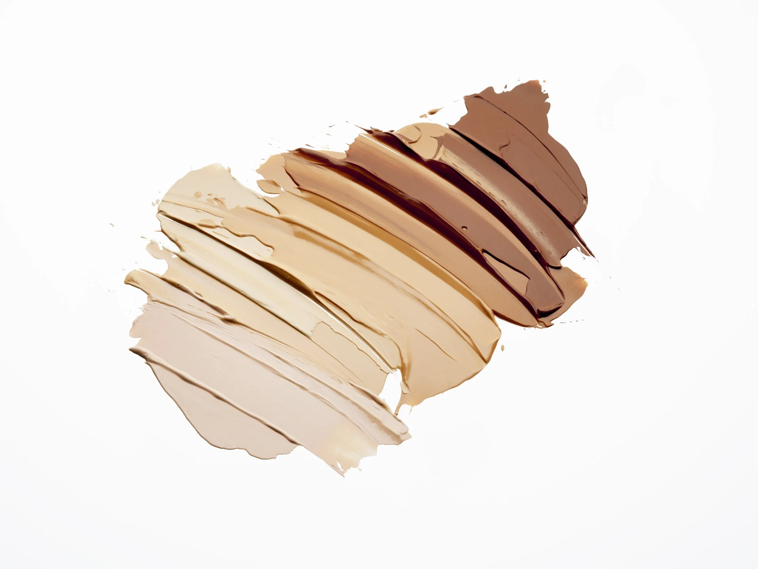 Swatches of different shades of makeup concealer or foundation on a white background.