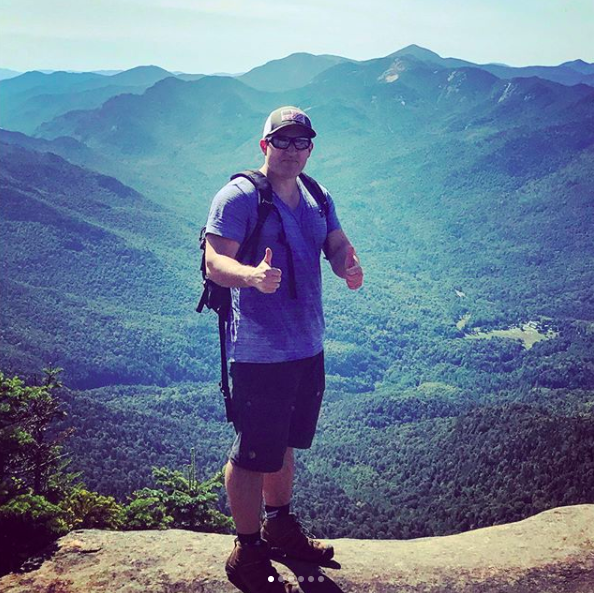Summit shot. Look to the right and north of my head and you'll see the outline of Marcy, the biggest mountain in New York. 