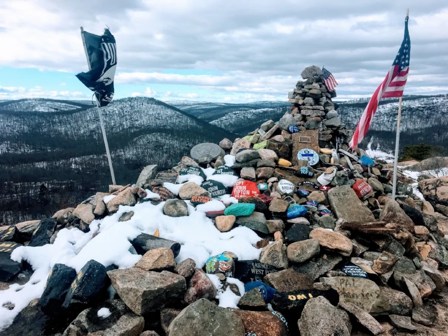 "These rocks were carried from the bottom and stacked here as a tribute to American soldiers now serving on the Frontier of Freedom. To their safe return."