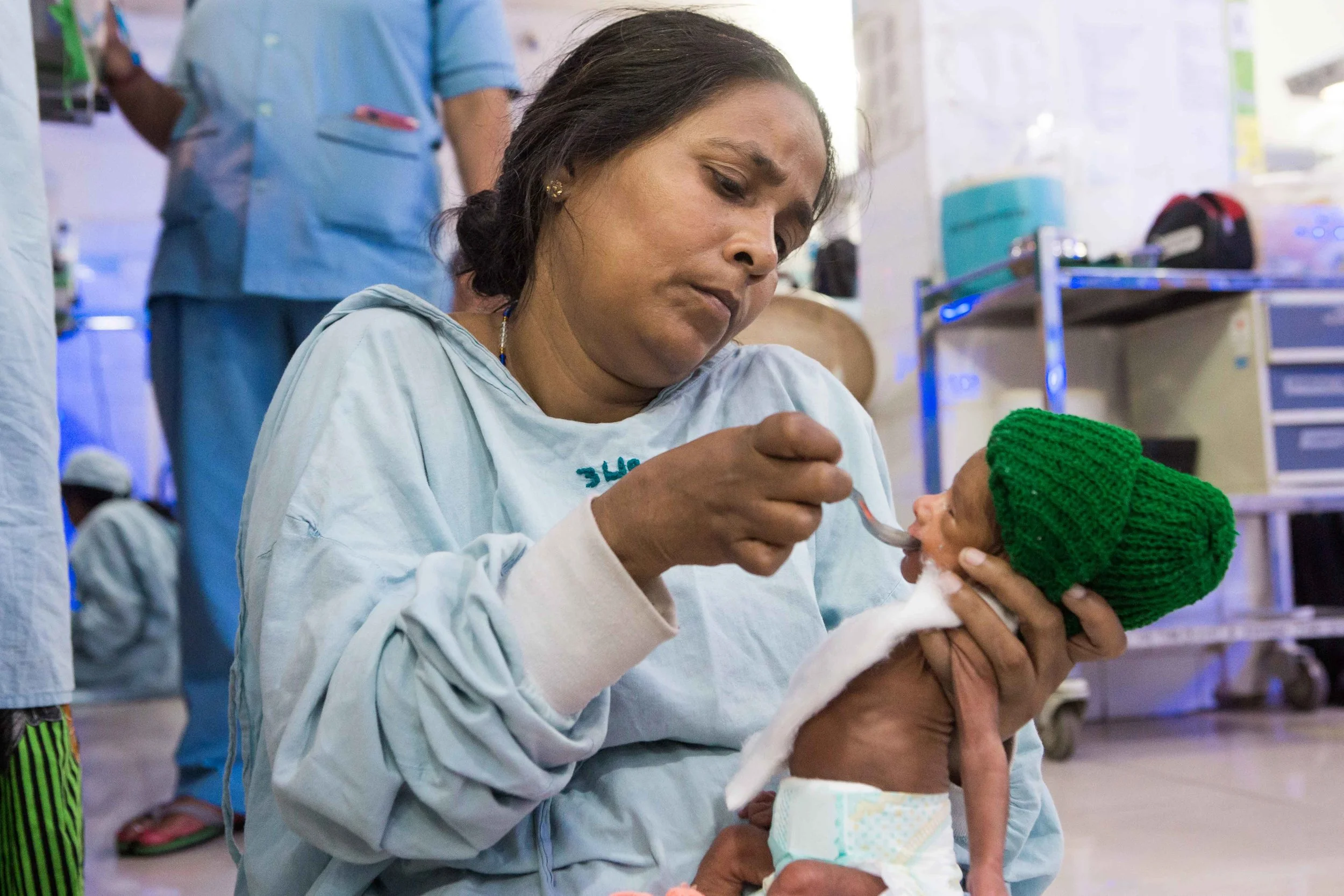 A mother feeds her ROP baby with her expressed breast milk because the child is too weak to suckle. NICU, Cuttack, Orissa