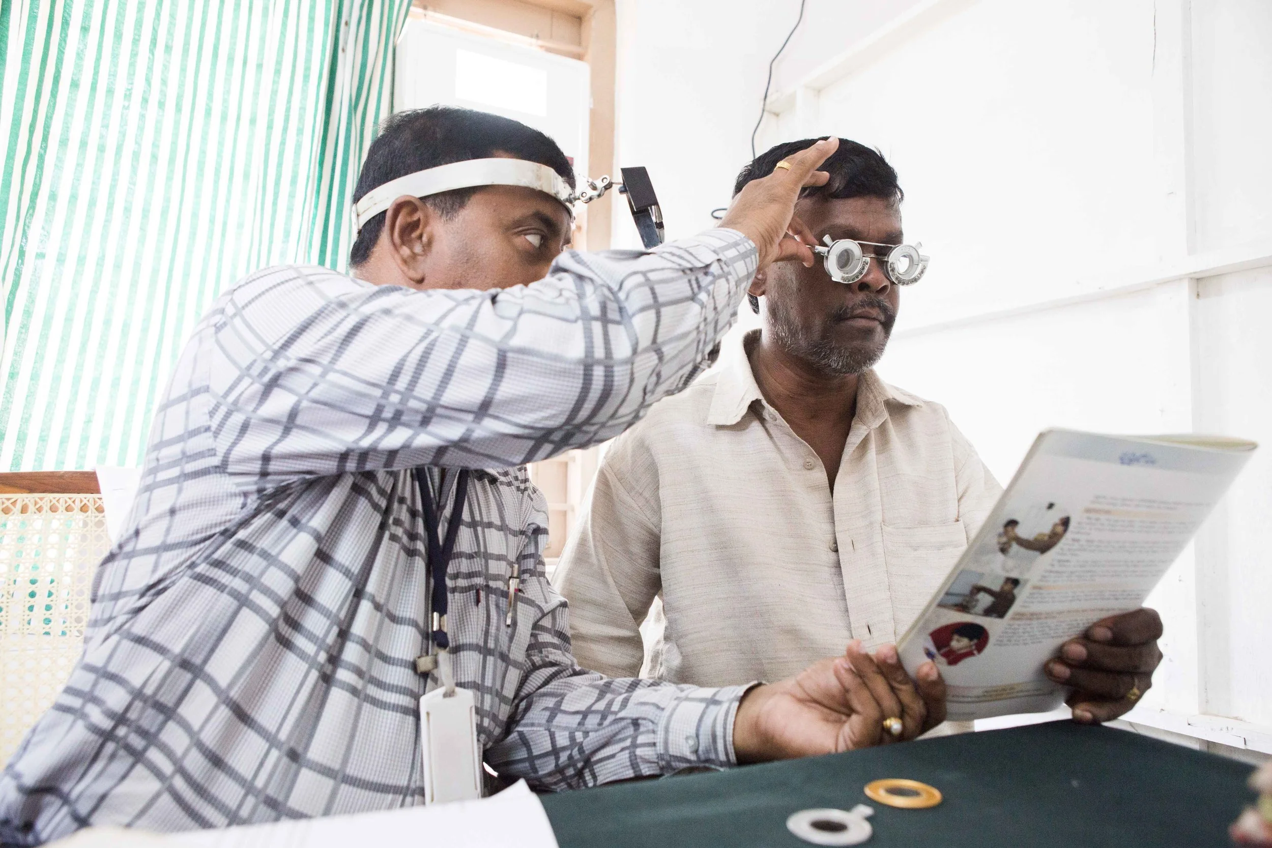 Optometry test in progress to detect extent of vision loss, Primary healthcare Centre Vizianagaram, Andhra Pradesh