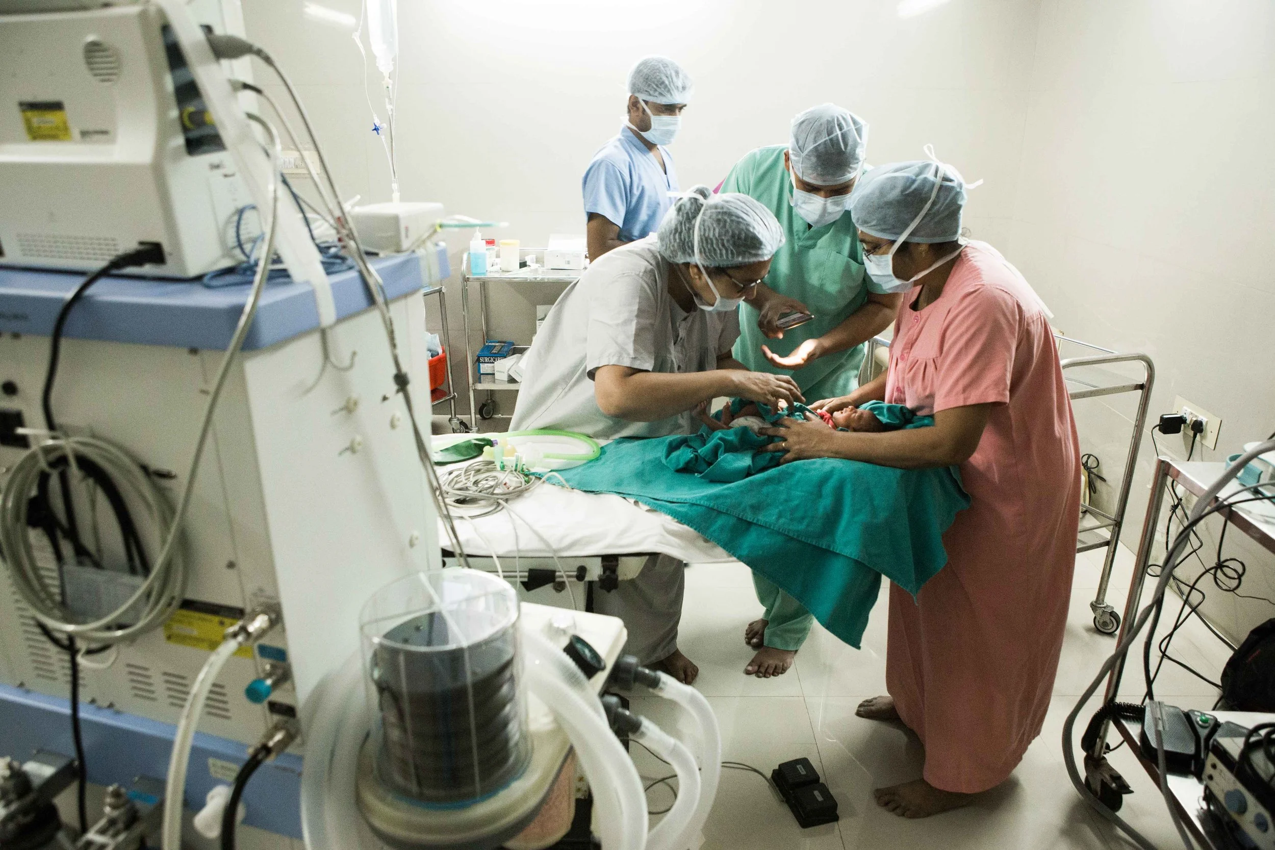 Doctors trying to find the babies vein for administering the anaesthesia before the Laser treatment on a ROP baby. PVRI Hyderabad