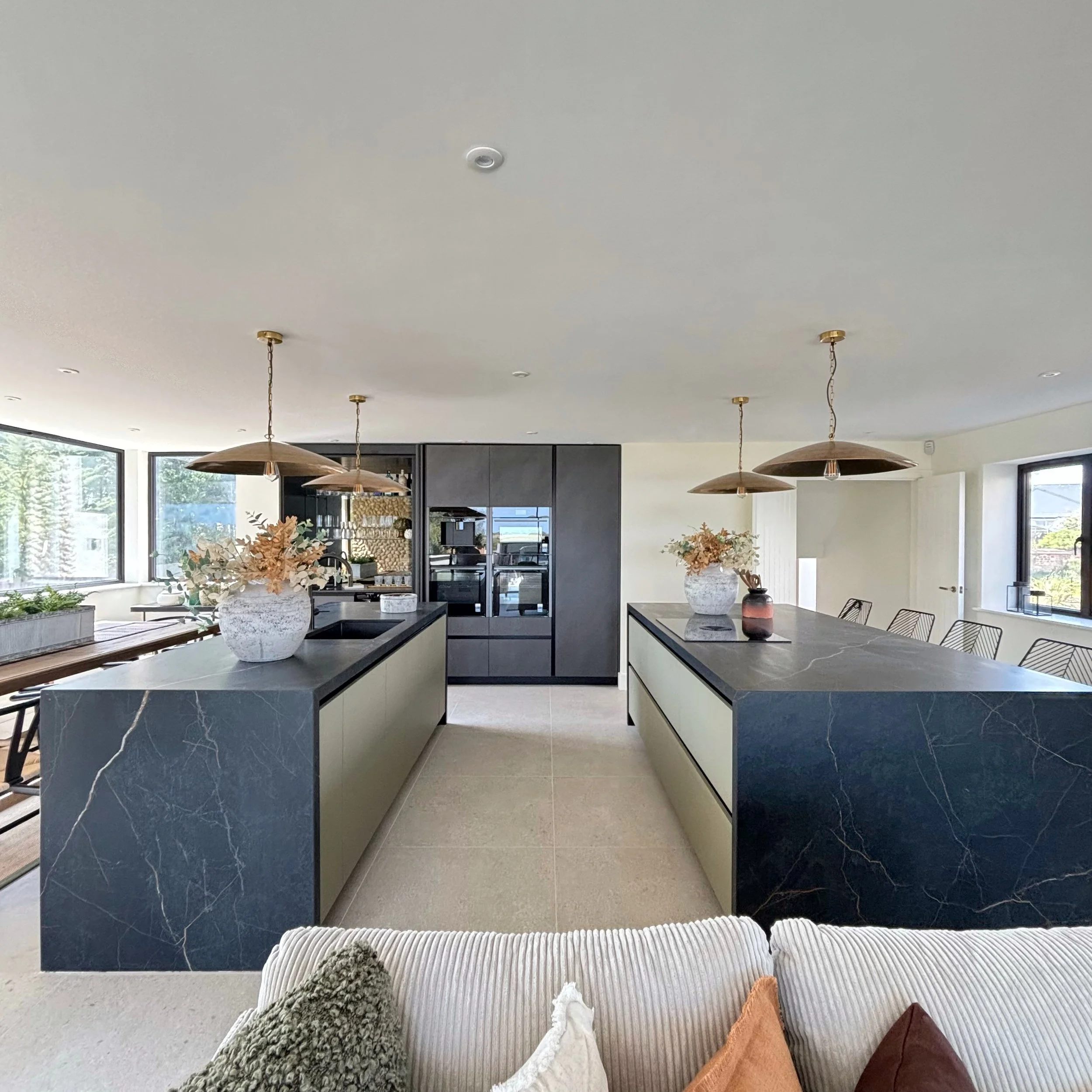 View of dual kitchen island, one with sink and dishwasher and the other with the hob for cooking