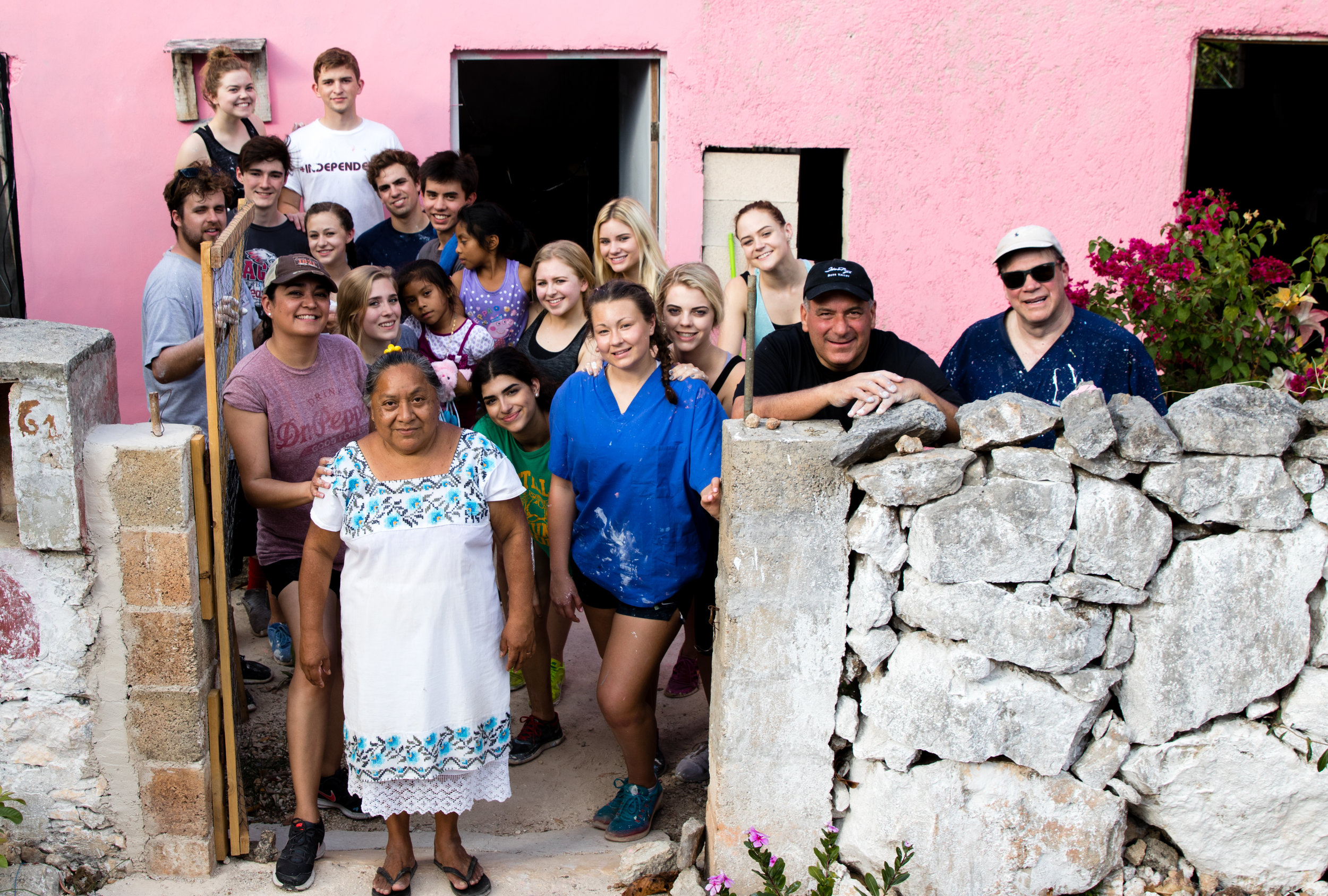 Group posing in front of pink painted house.jpg