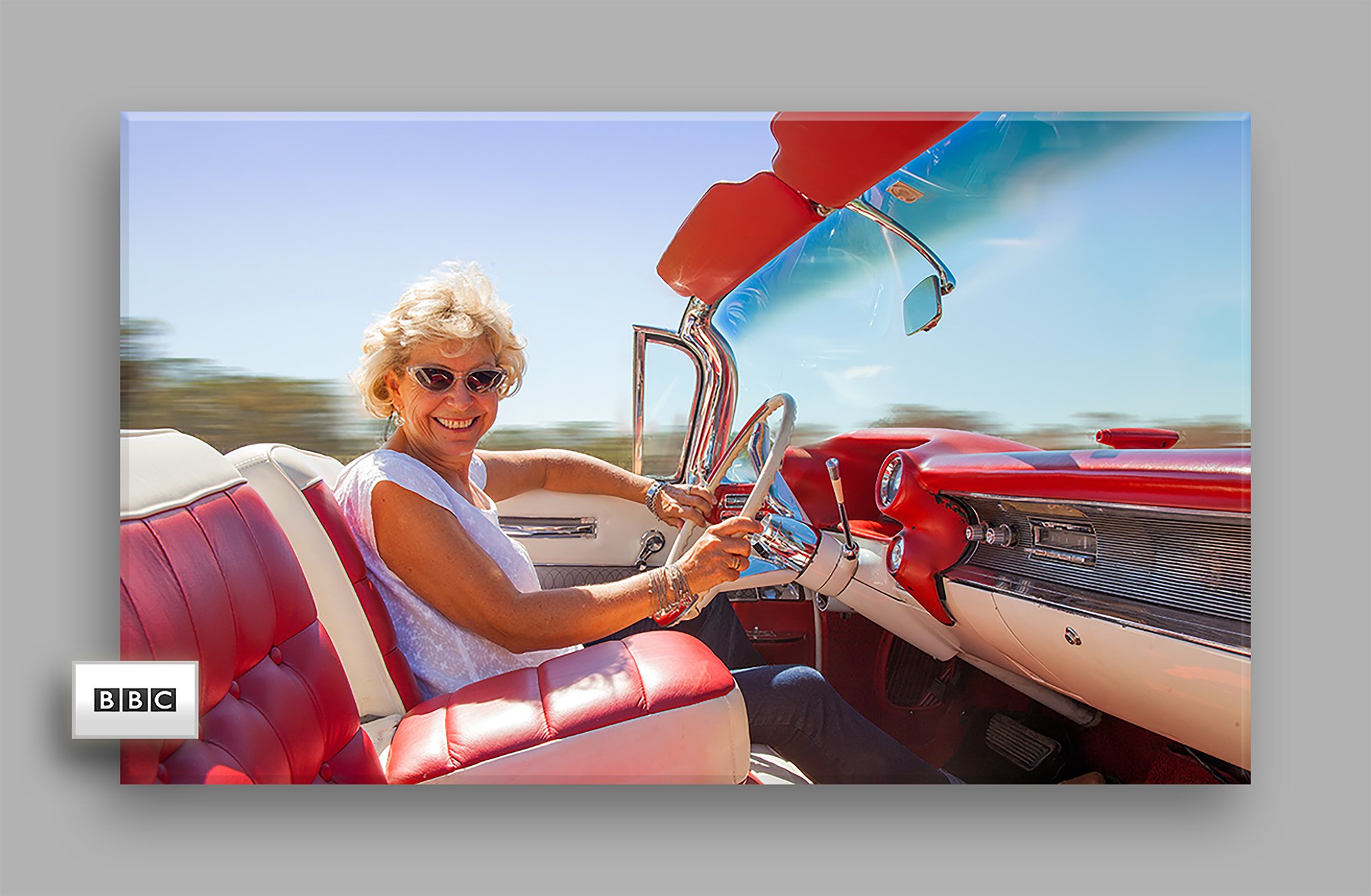 Portrait of Hilary Kay driving a Cadillac for the Radio Times