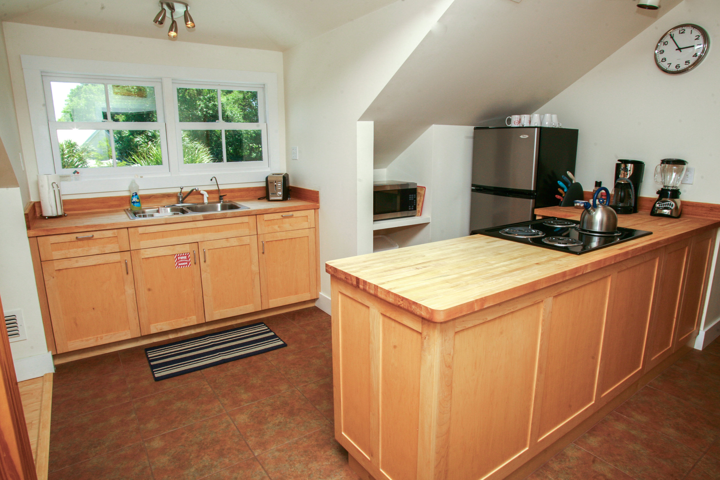Fully equipped kitchen with loads of sunlight! All custom cabinetry.