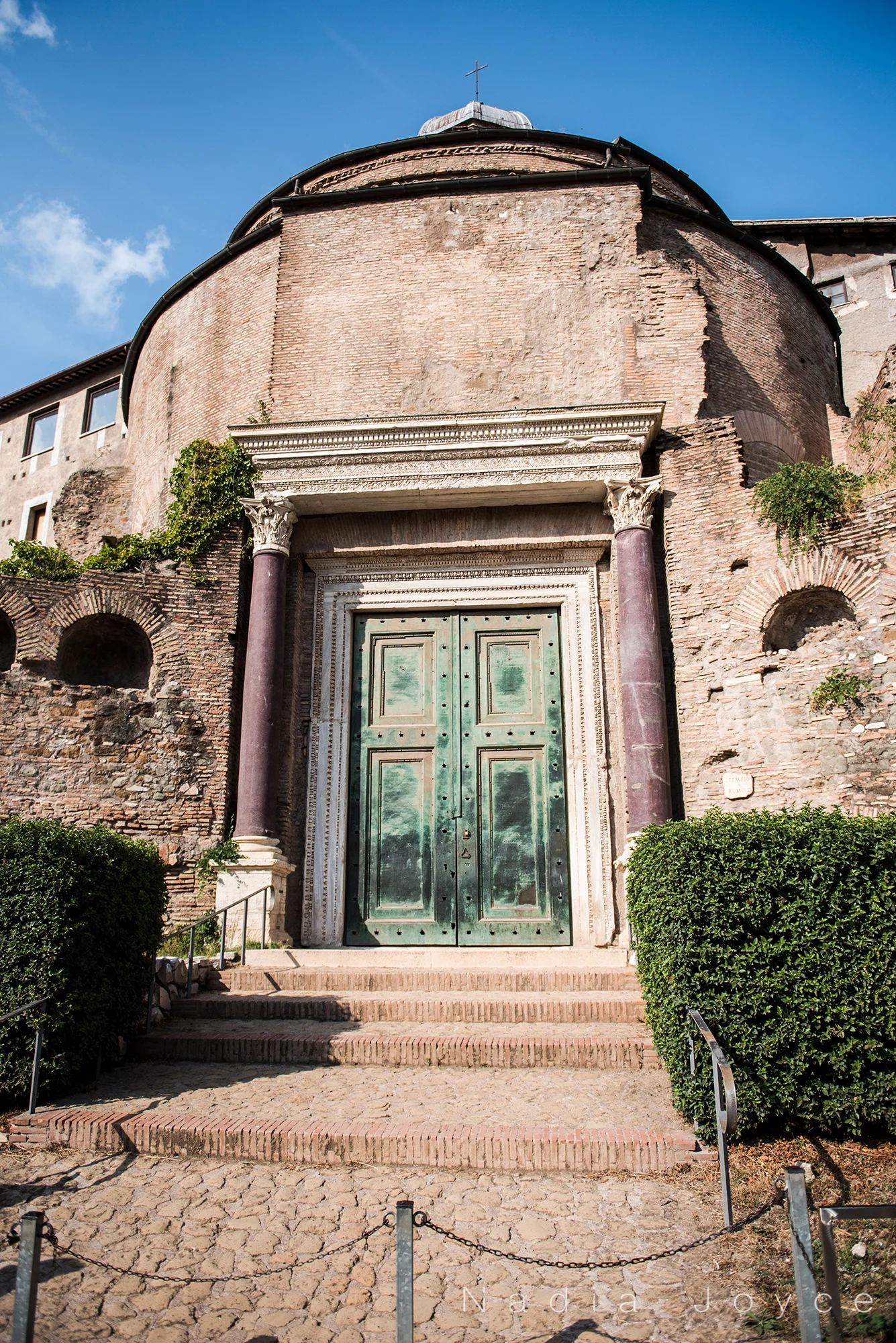 The green door to the Temple of Romulus. This is the original door to this place. And those purple columns on each side are made of a material called porphyry , which is an incredibly valuable material that we would end up seeing a lot more of during our explorations of important places in Italy.
