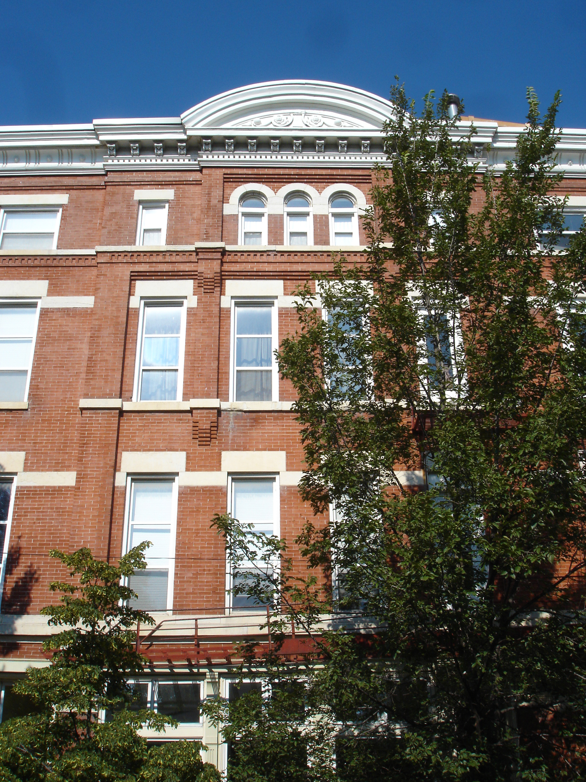 multi-family residential gut renovation, 1890s brick masonry apartment building, converted storefronts into residences, new two-story units, roof deck