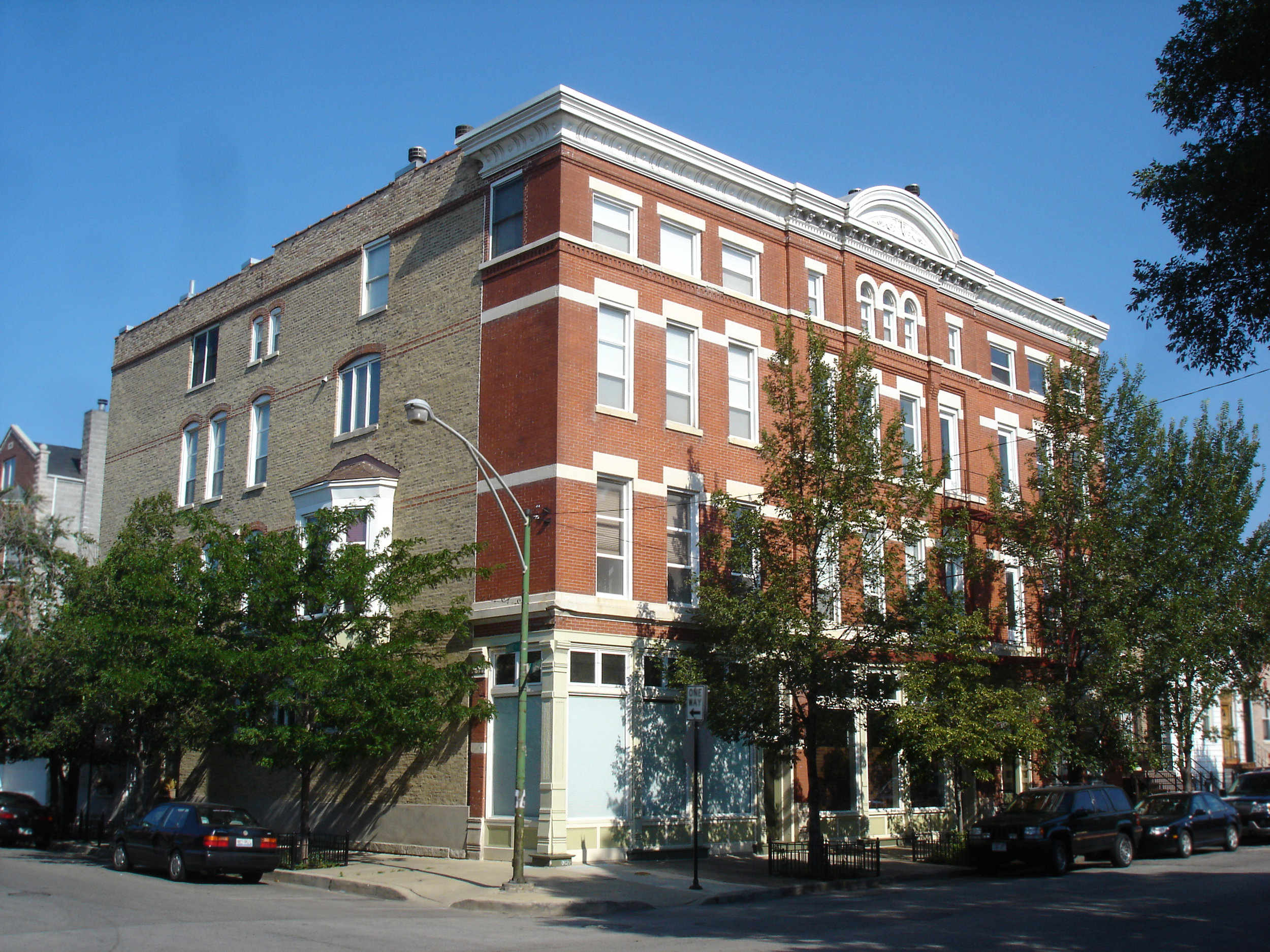 multi-family residential gut renovation, 1890s brick masonry apartment building, converted storefronts into residences, new two-story units, roof deck