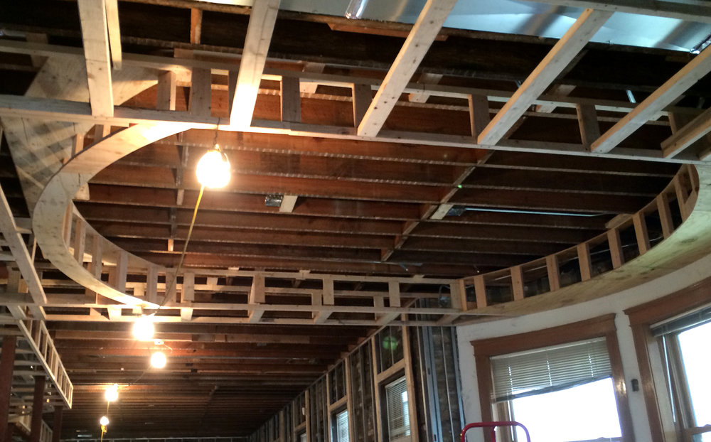 Site visit photo: construction of a drop ceiling with cove lighting above a dining room