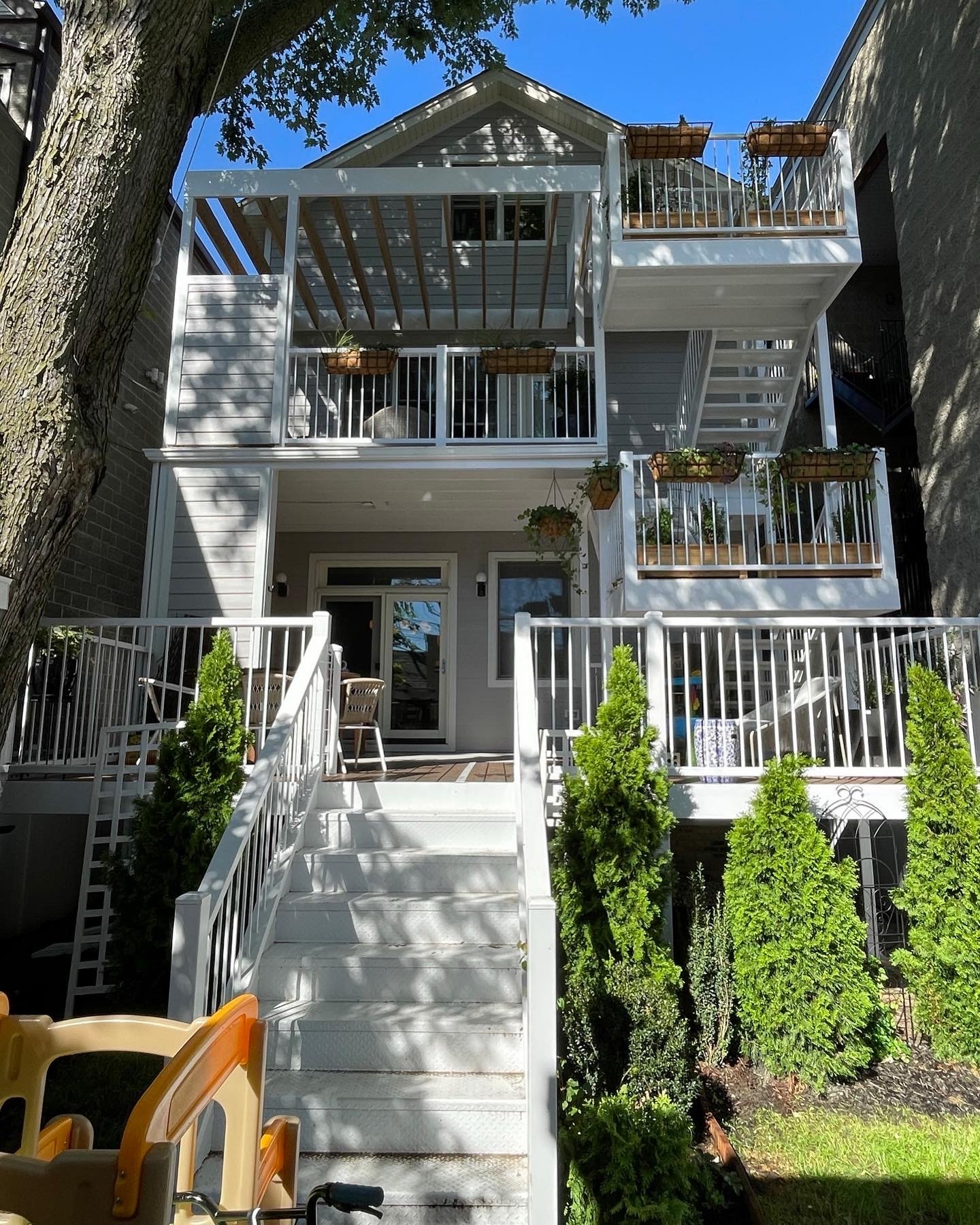 front elevation view of a new three-story backyard deck and stairs