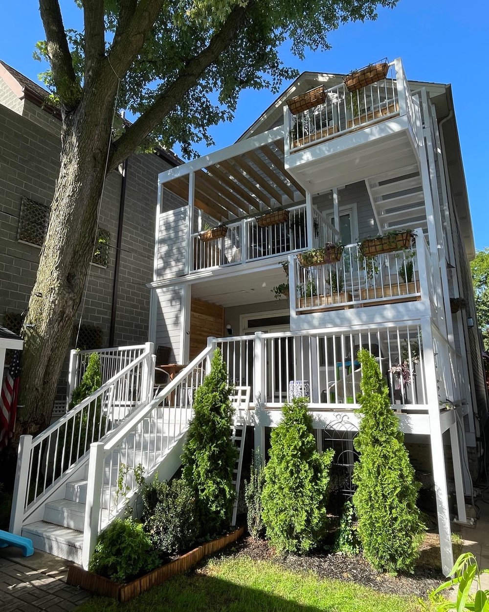 A new, modern, three-story wood and metal deck and stairs