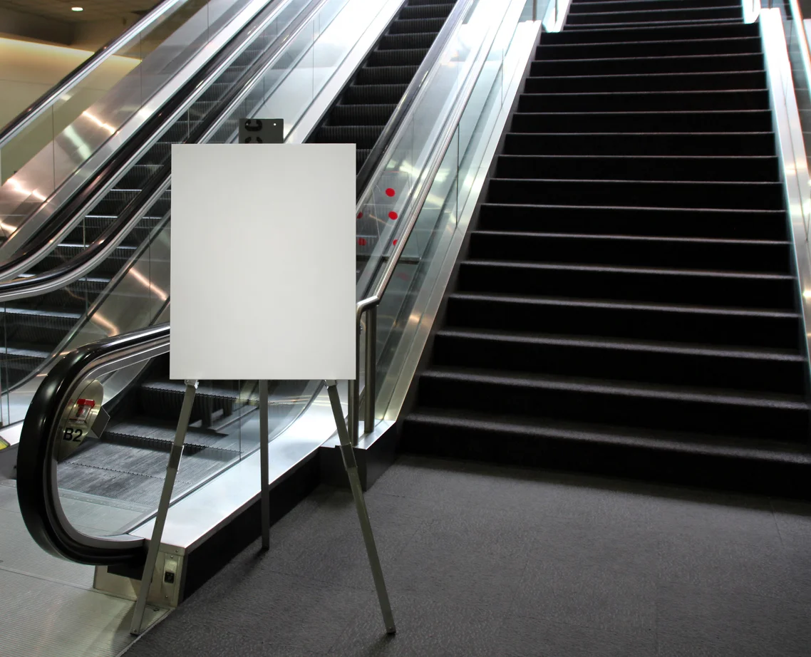 Blank-easel-sign-at-the-base-of-an-escalator-538805150_1140x923.jpeg