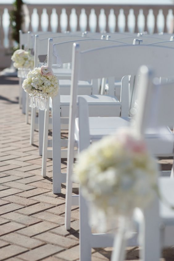 white resin folding chair with bouquets.jpg